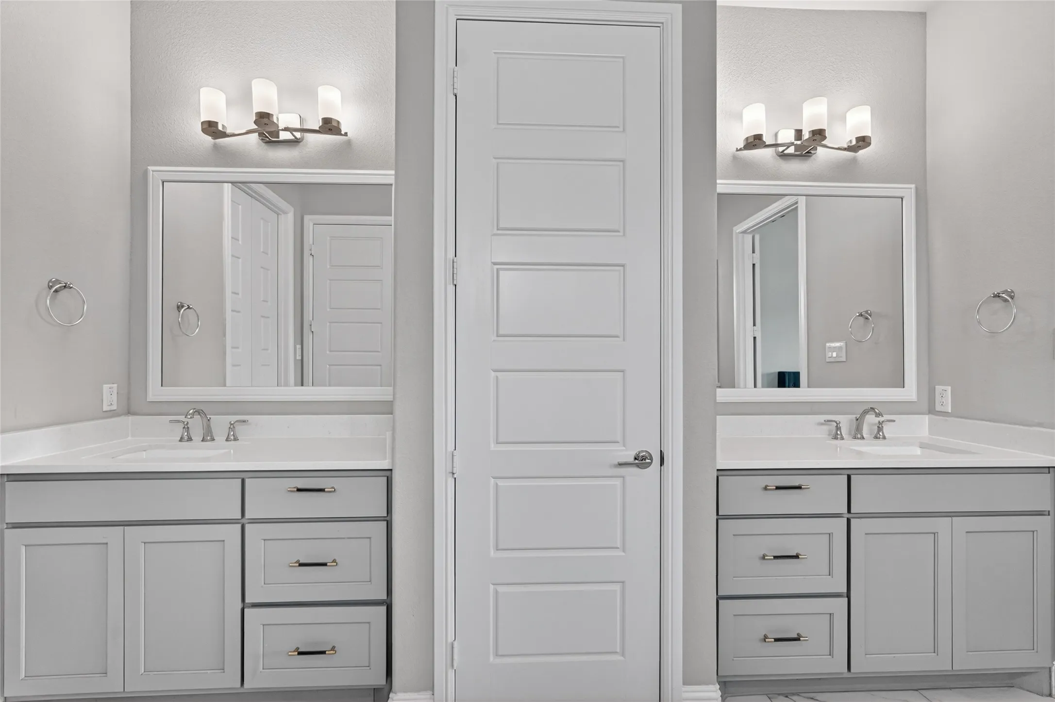 Dual vanity with shaker-style cabinetry, white countertops, and undermount sinks