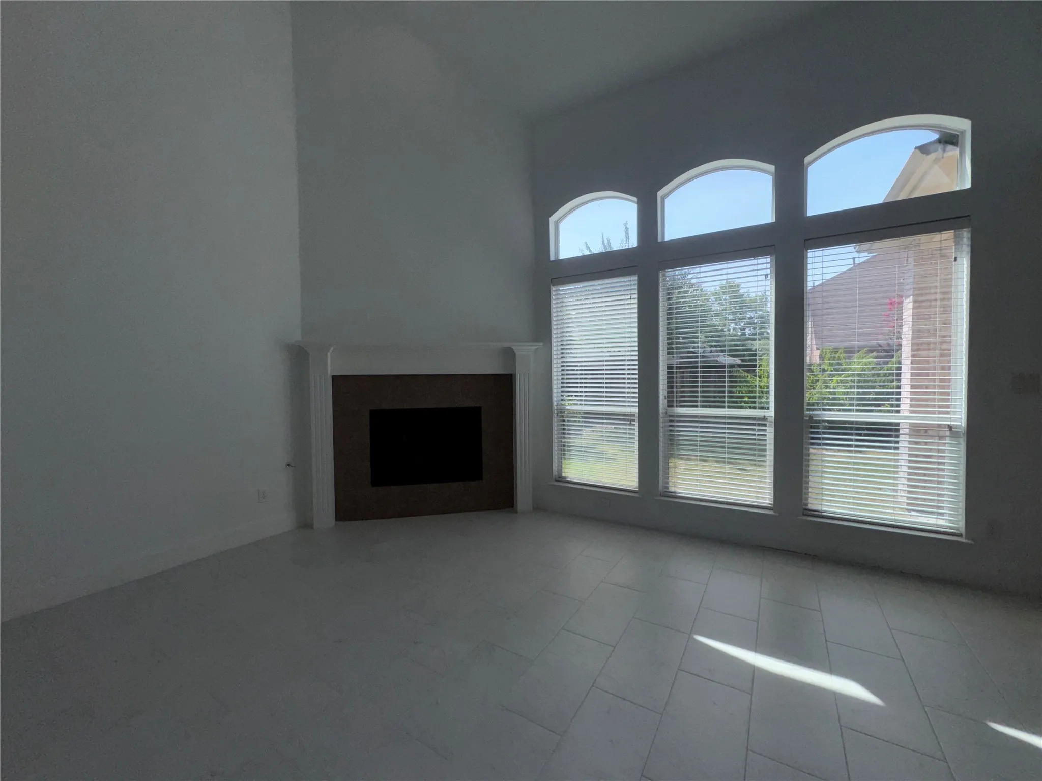 Vaulted ceilings over a fireplace with a traditional mantel and hearth