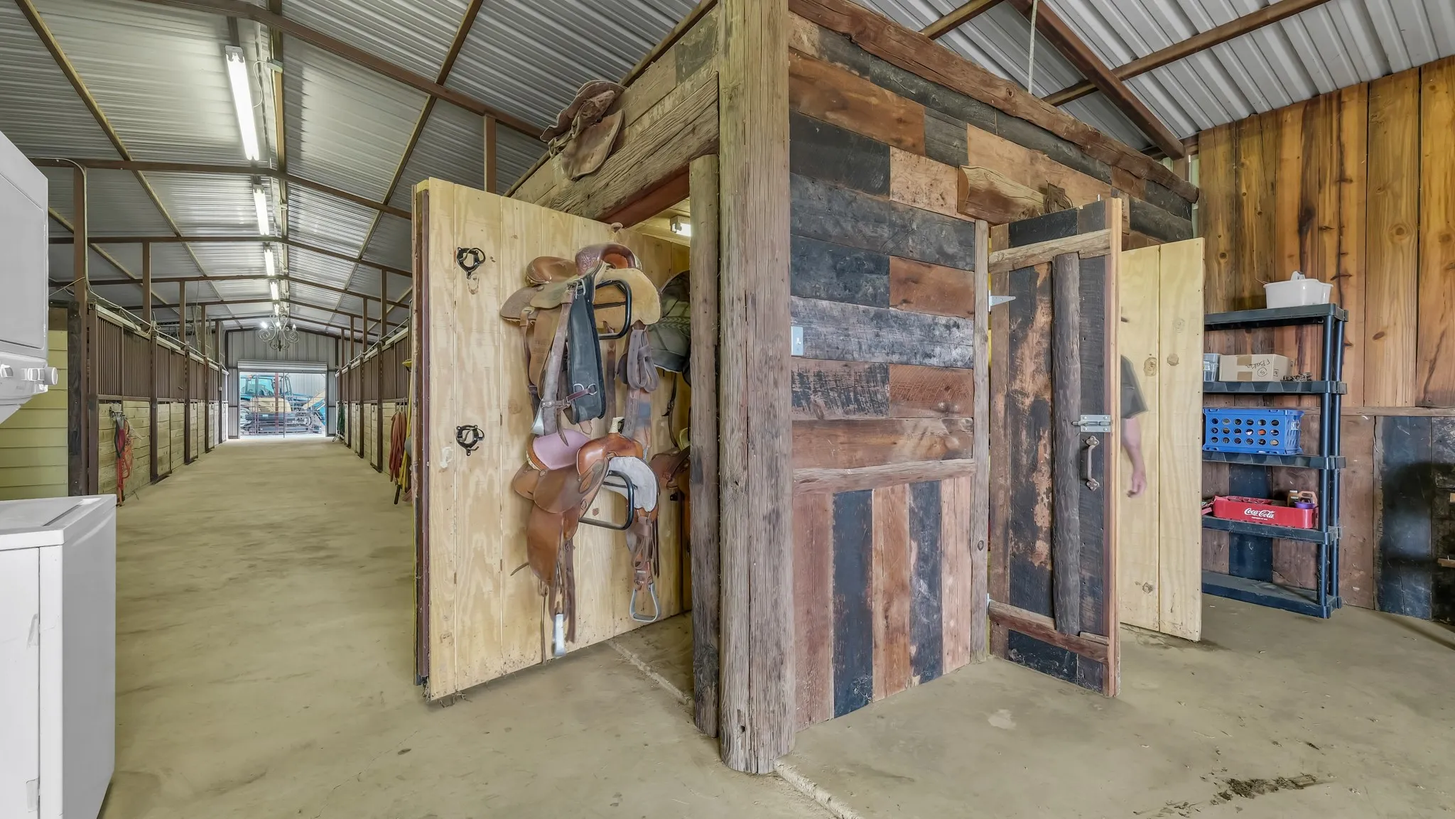 Horse barn with concrete flooring and exposed metal framing