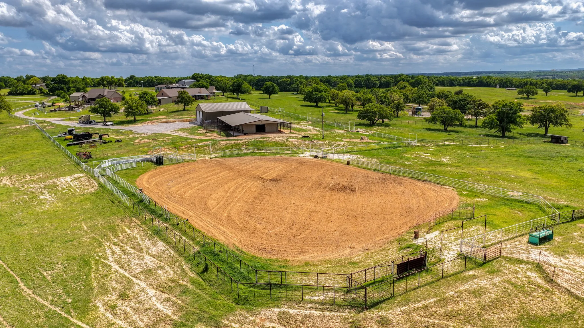Expansive outdoor arena featuring a sand surface and perimeter fencing