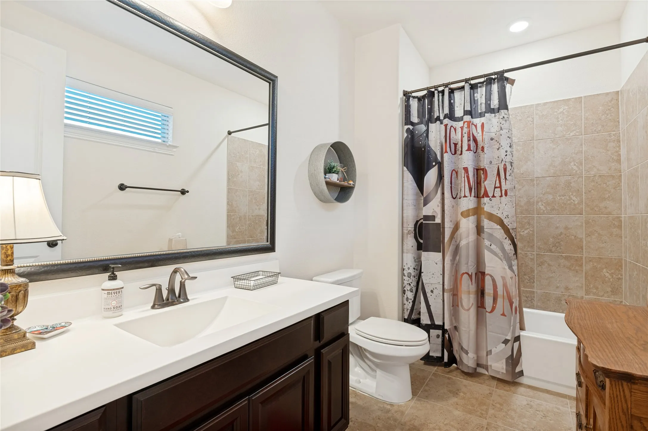 Bathroom featuring a dark wood vanity with a white countertop and undermount sink