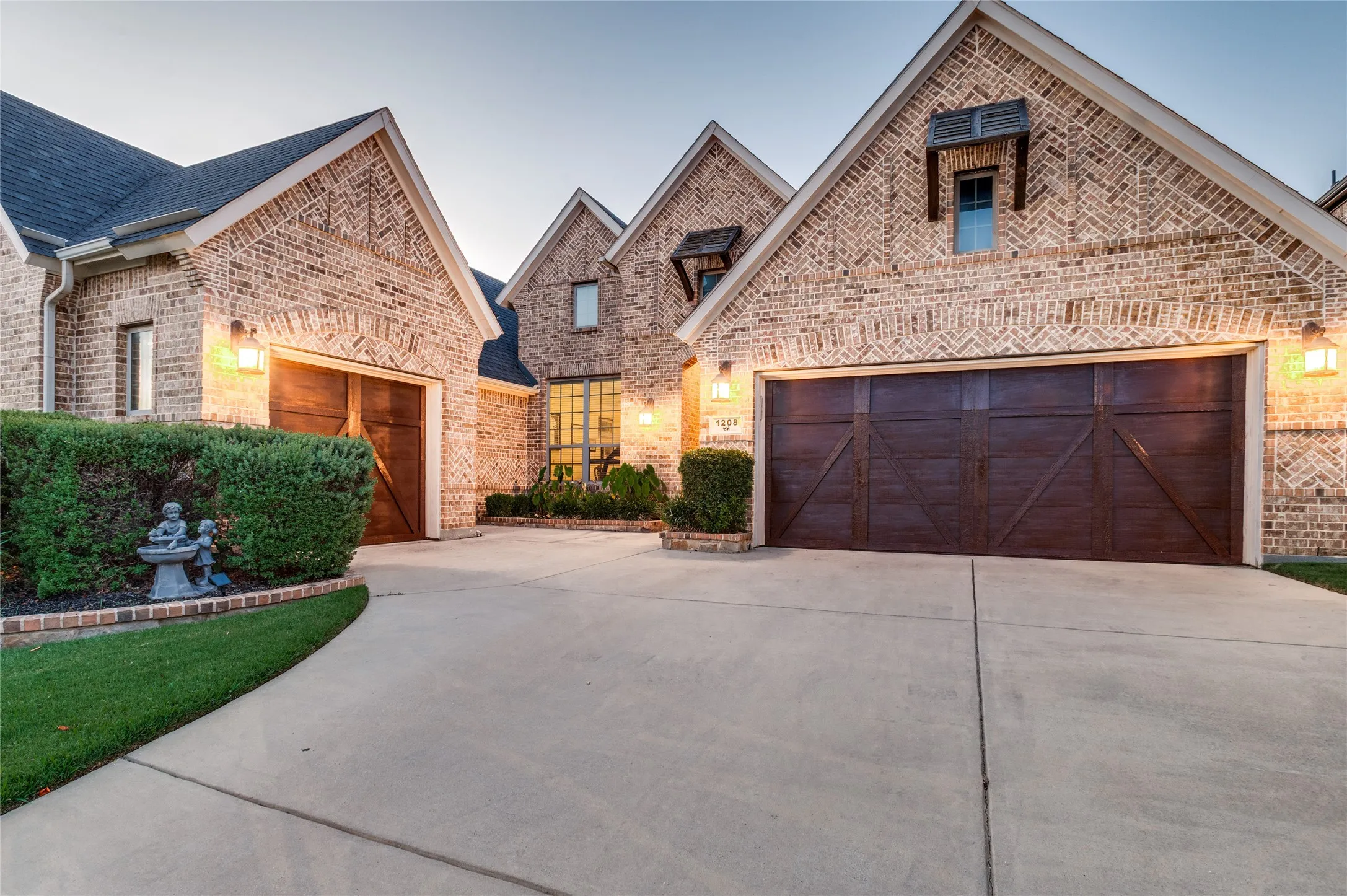 Brick exterior featuring multiple gables and a dark shingle roof