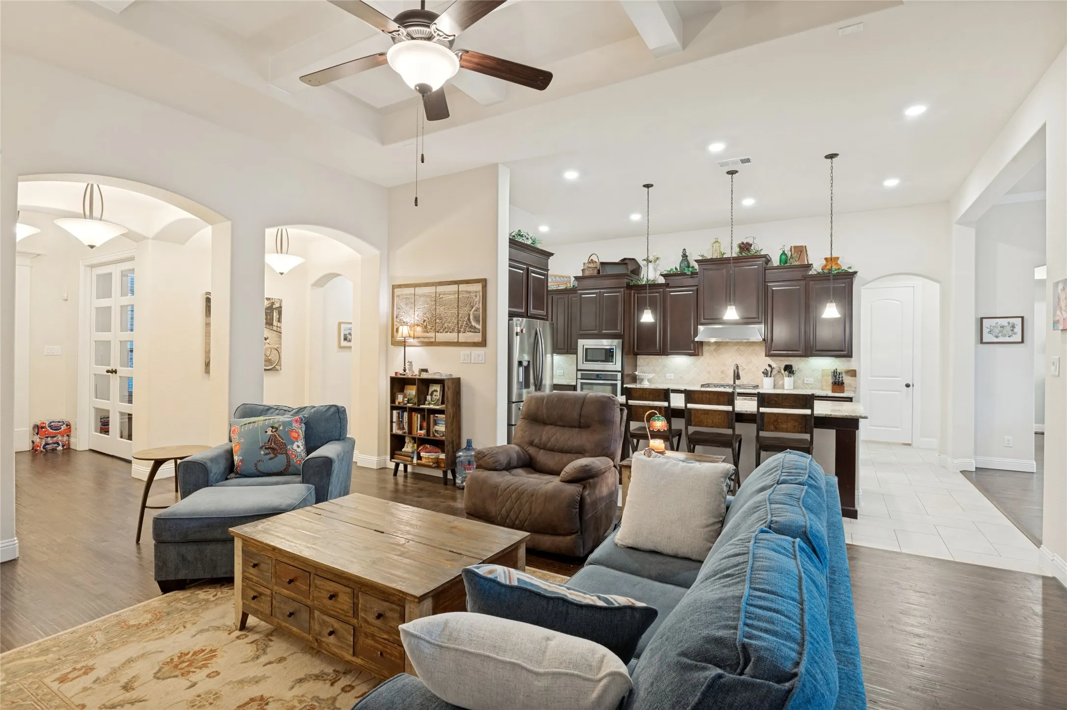 Living area with coffered ceiling and dark wood-finish flooring