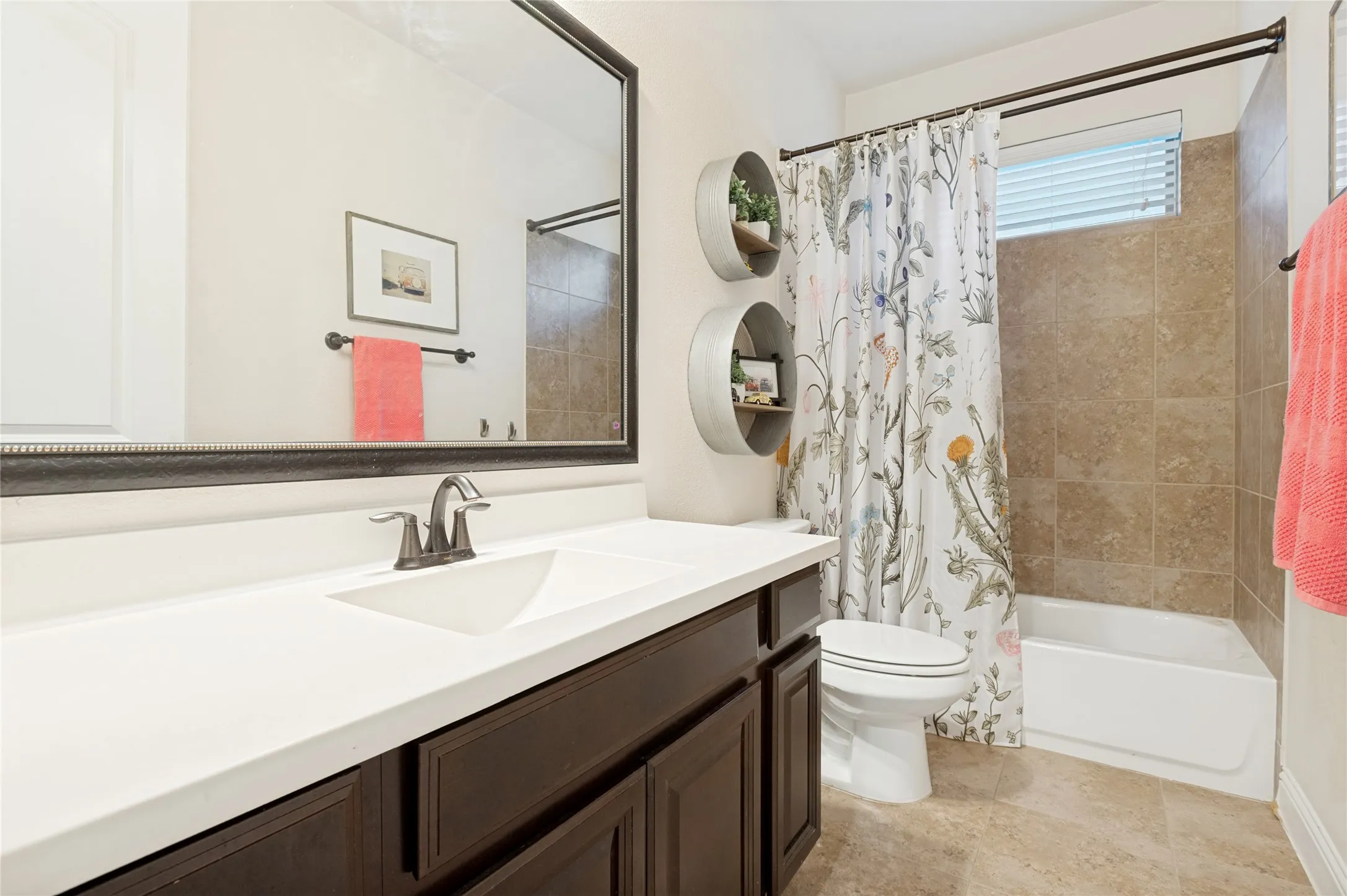 Bathroom featuring a dark wood-finish vanity with a white countertop and integrated sink