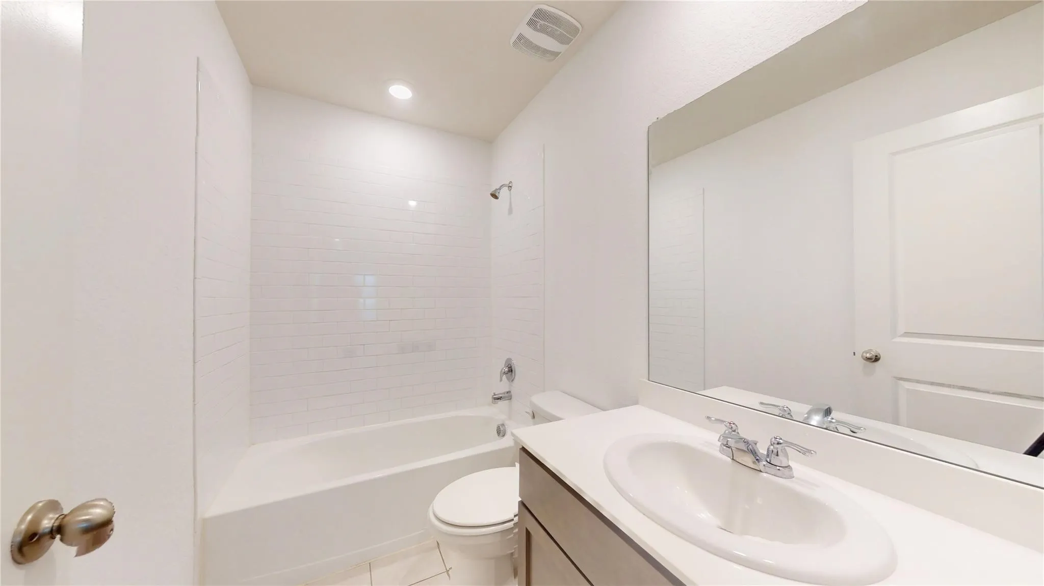 Bathroom featuring a white subway tile surround shower and tub combination