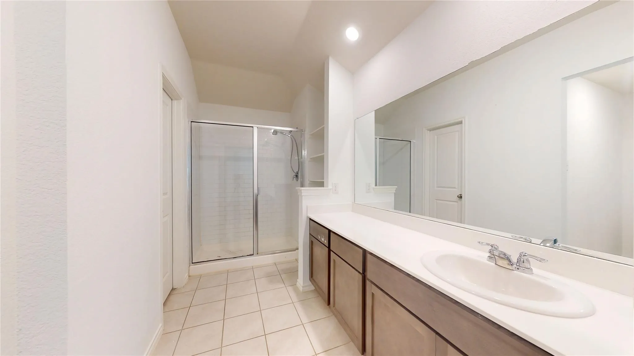White countertop vanity with integrated sink and chrome faucet