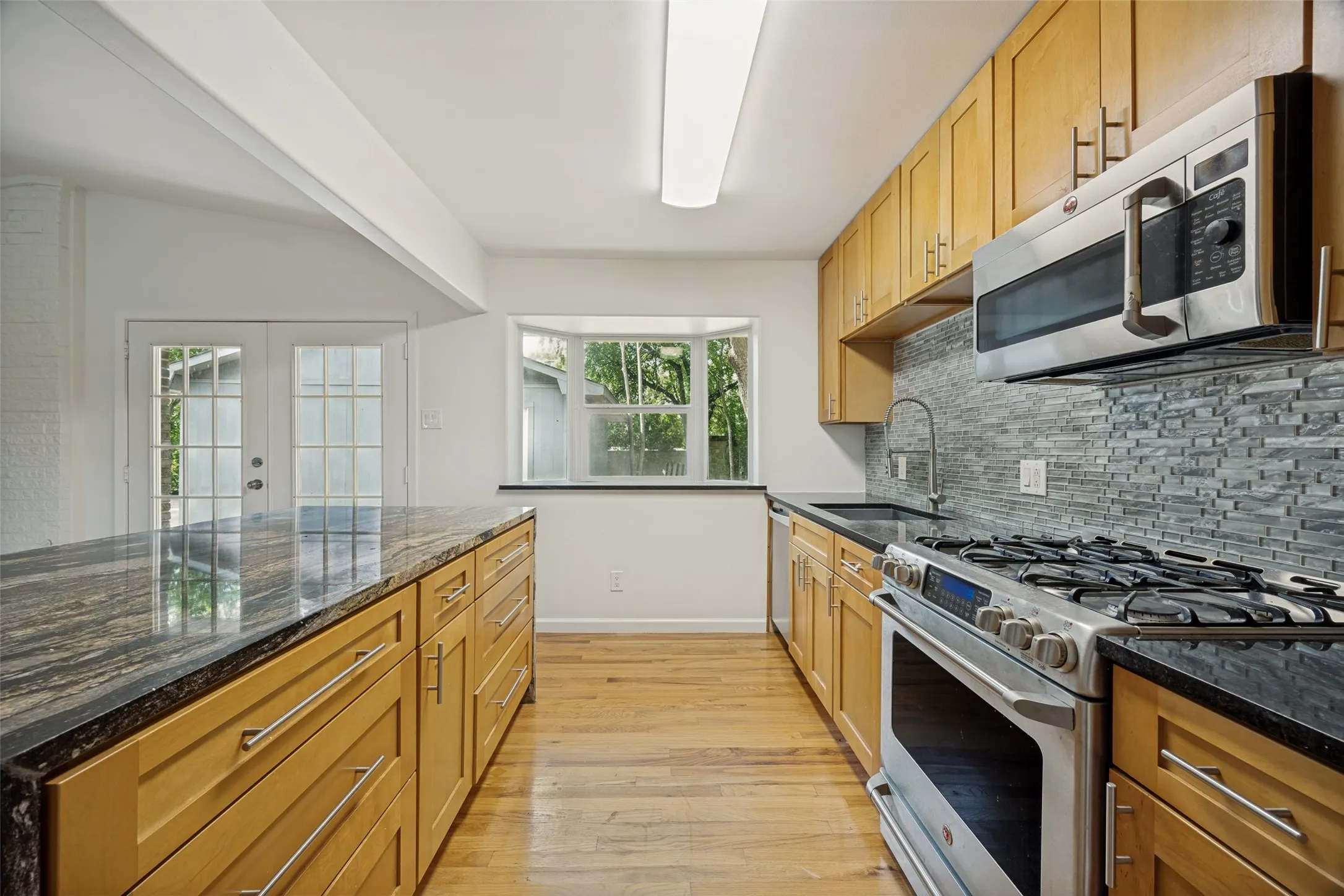 Kitchen featuring wood-finish cabinetry, granite countertops, and stainless steel appliances