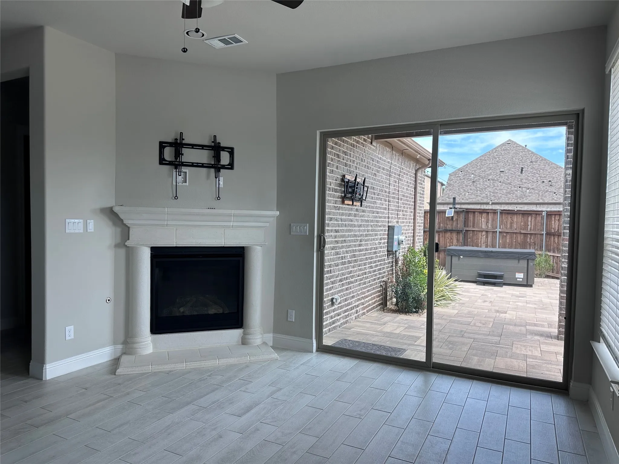 Corner fireplace with a cast stone surround and hearth