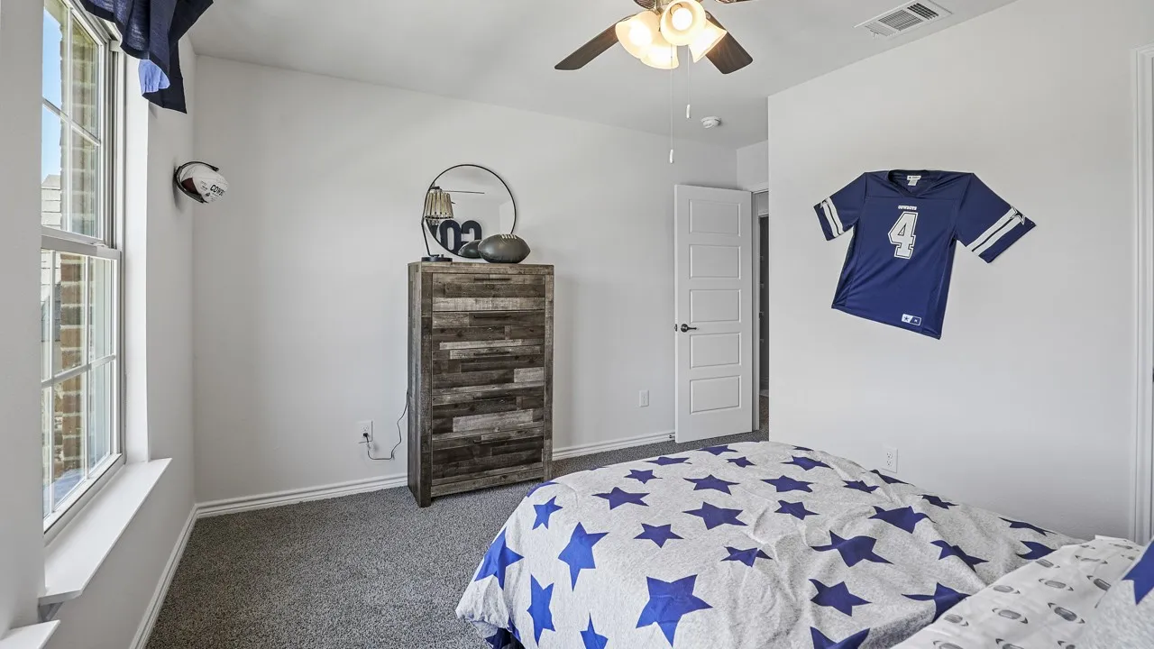Carpeted loft area with recessed lighting, a ceiling fan, and two large windows