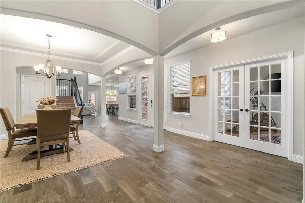 Versatile layout showcasing the dining room with doors to side patio and access to oversized office/home gym