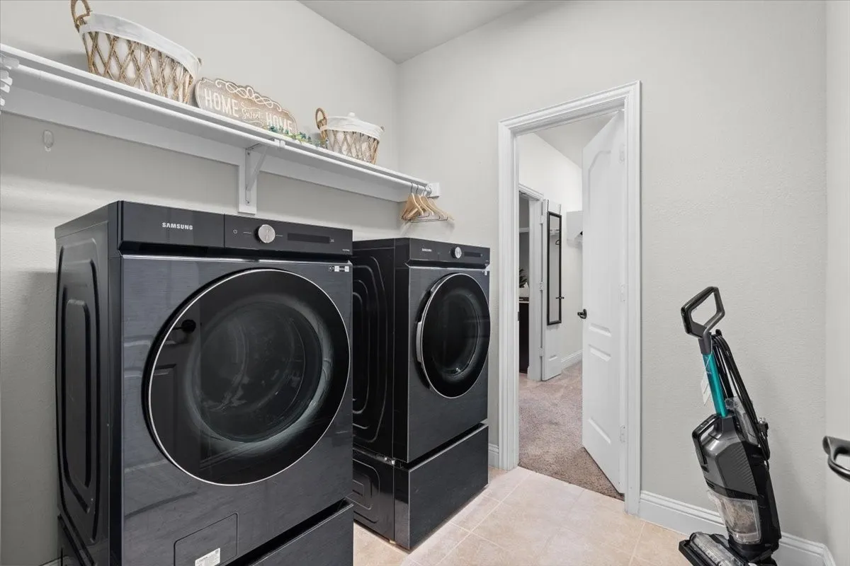 Large laundry with access to expansive primary closet