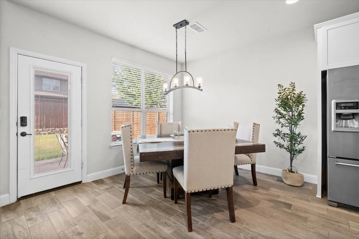 Bright breakfast nook with patio access and backyard views