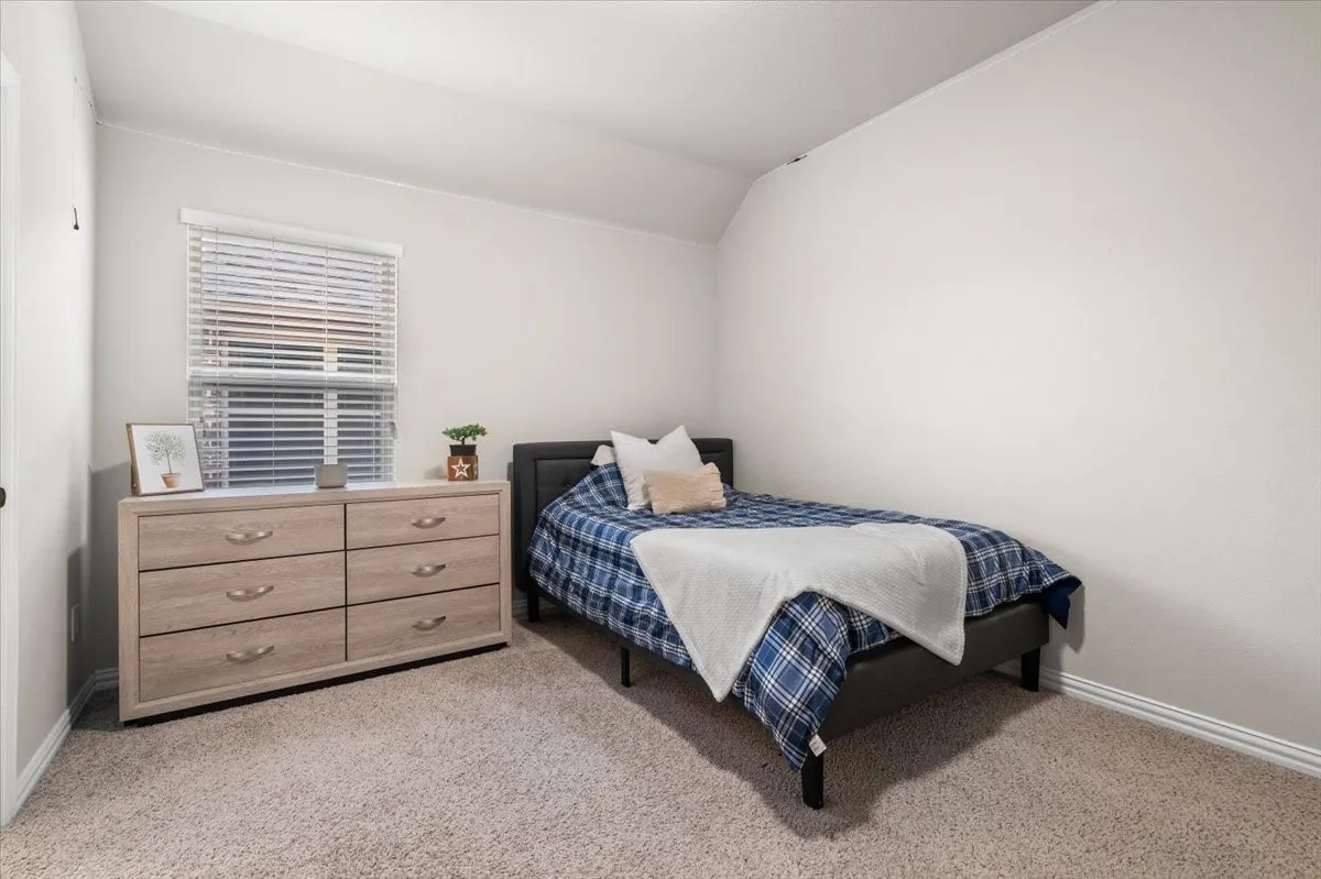 Comfortable third bedroom with natural light and a spacious closet