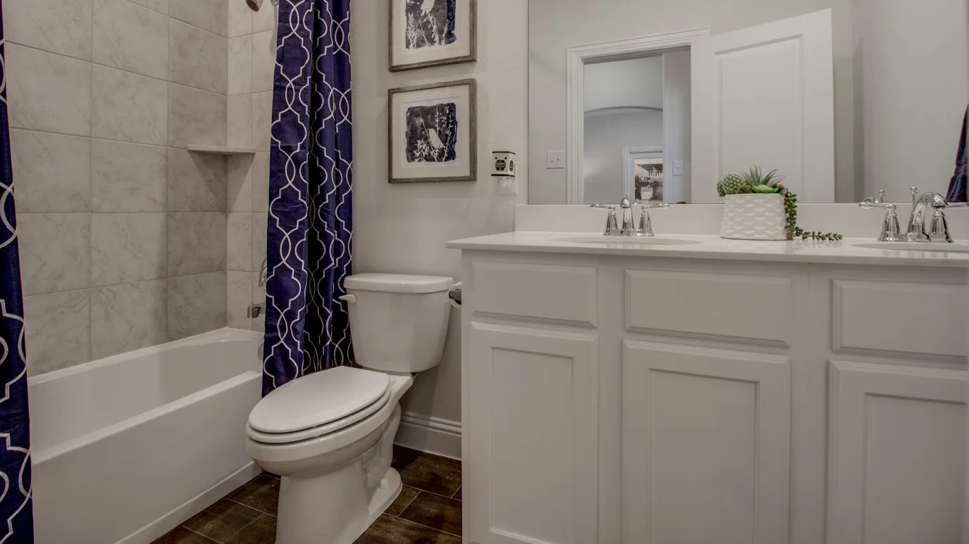 Dual vanity with white cabinetry, integrated sinks, and chrome faucets