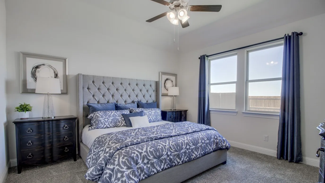 Bedroom featuring carpet flooring, a vaulted ceiling, and dual windows