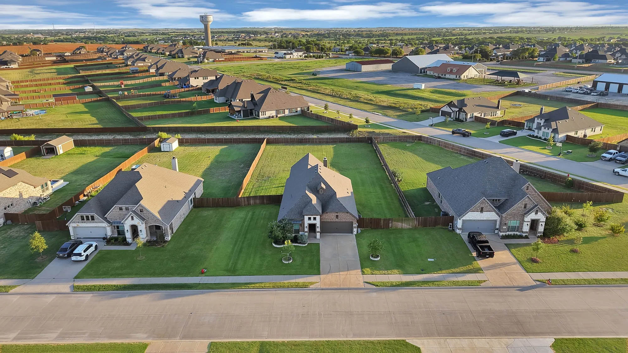 Aerial view showcasing residential properties with established landscaping