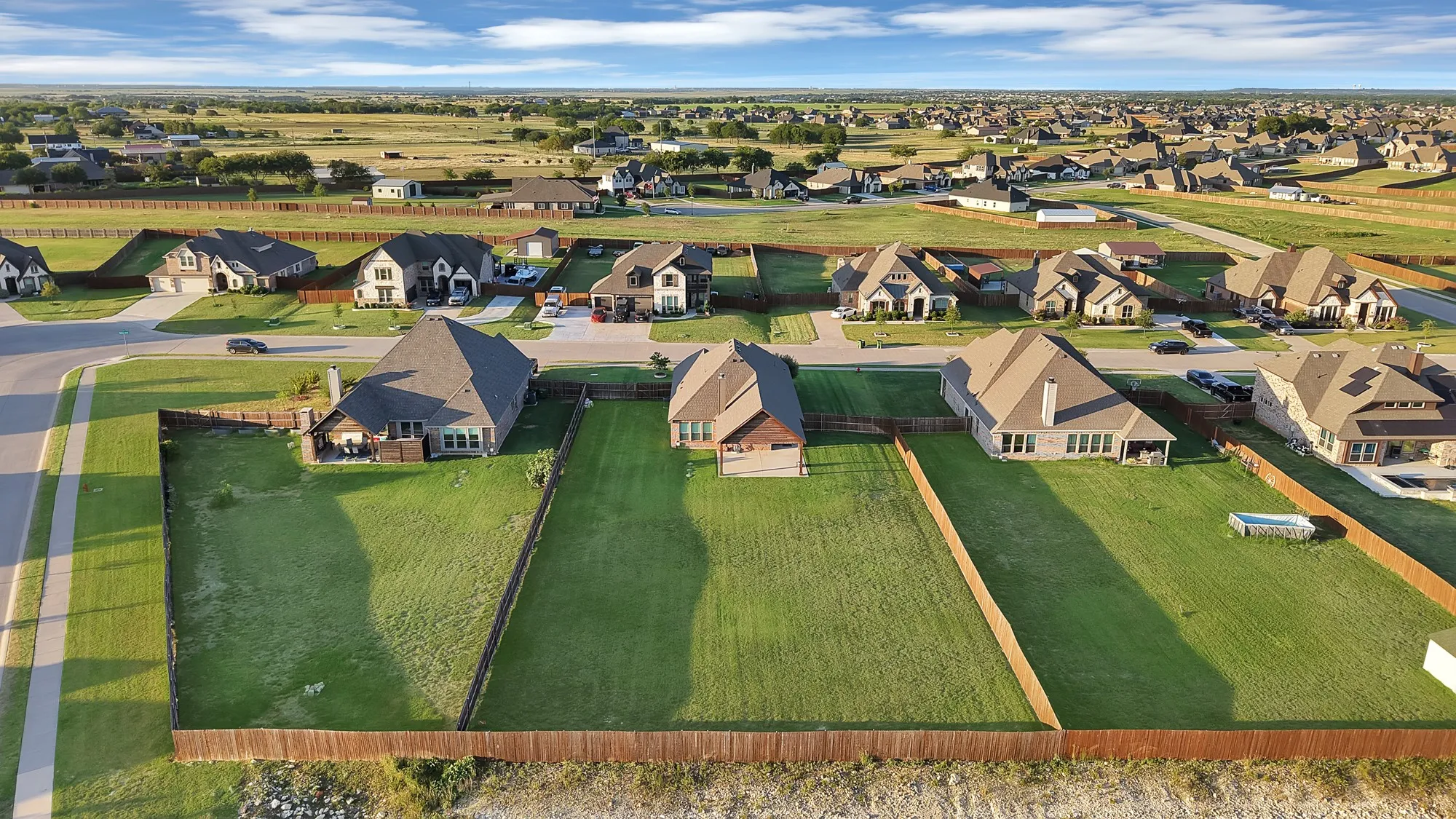 Expansive residential neighborhood featuring single-family homes with pitched roofs and manicured​​‌​​​​‌​​‌‌​‌‌​​​‌‌​‌​‌​‌​​​‌​​ lawns