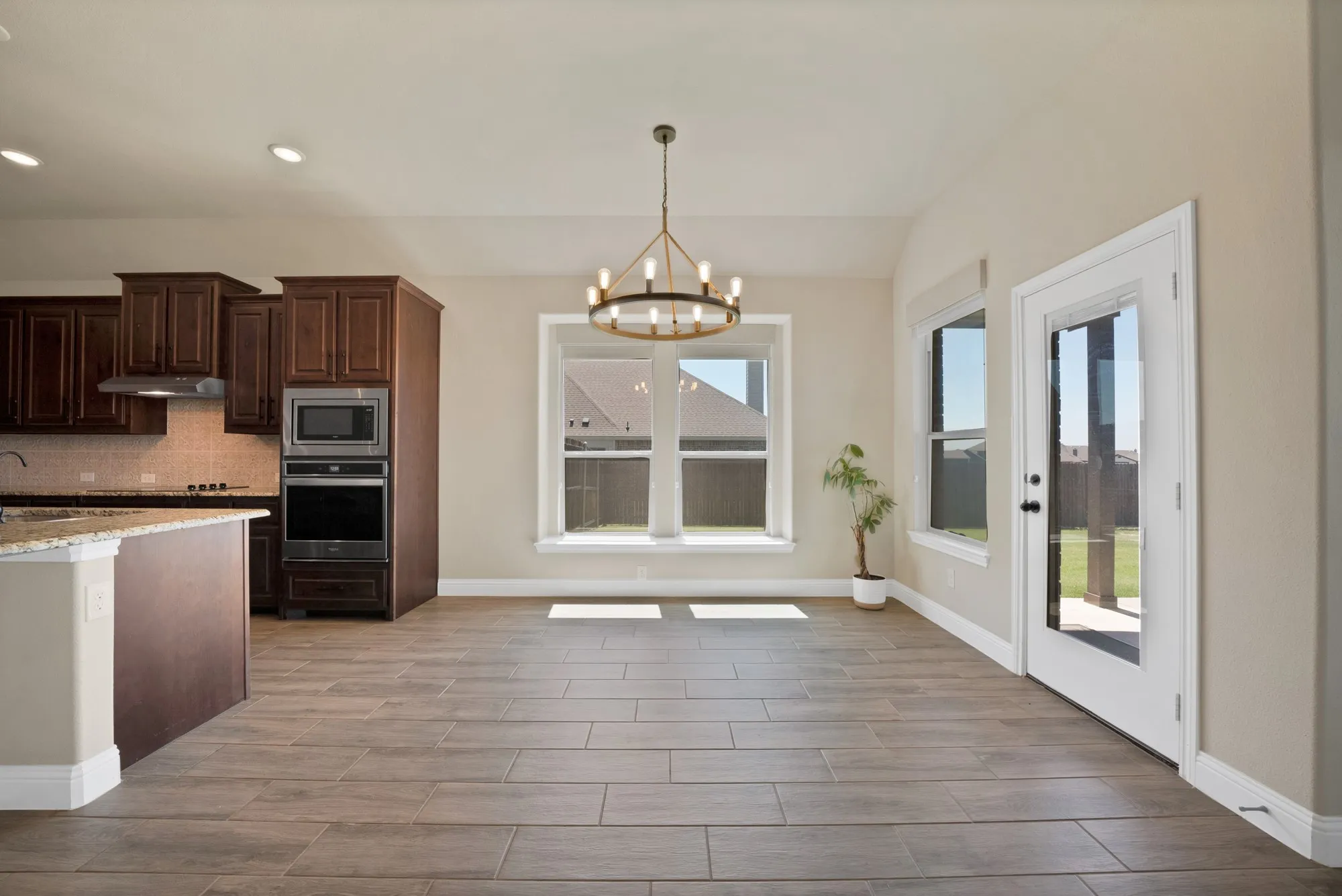 Spacious kitchen and dining area with wood-finish flooring