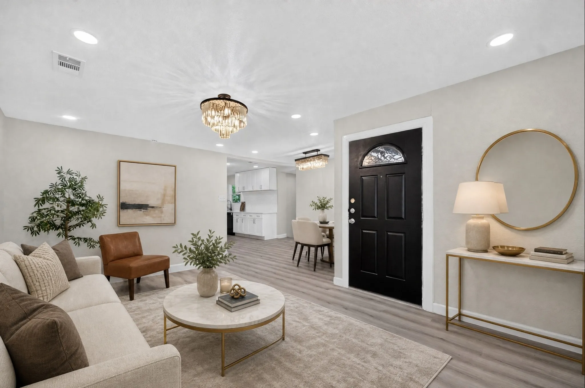 Open-concept living space featuring recessed lighting, a modern chandelier, and wood-finish flooring