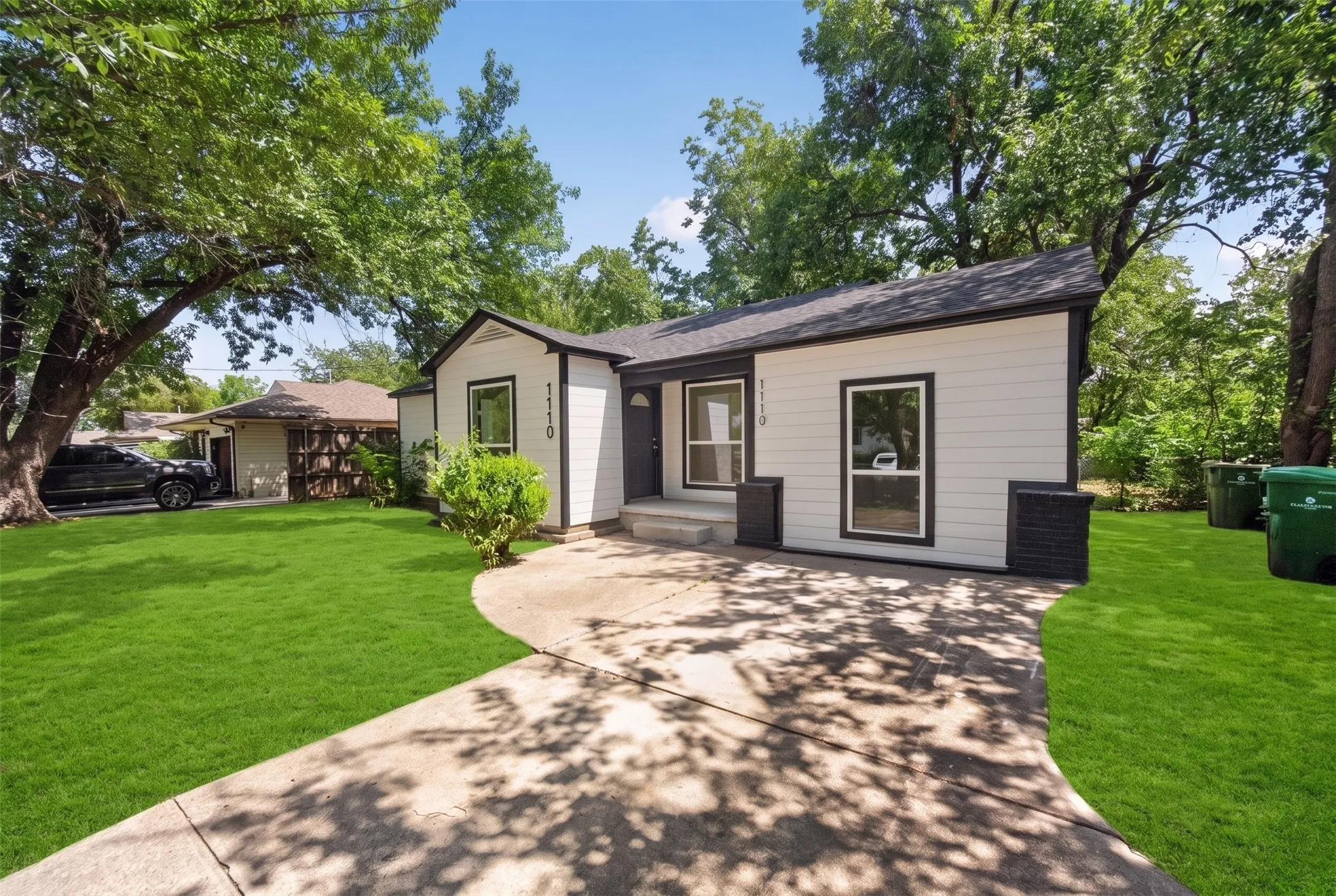 Contemporary exterior with white siding and dark trim