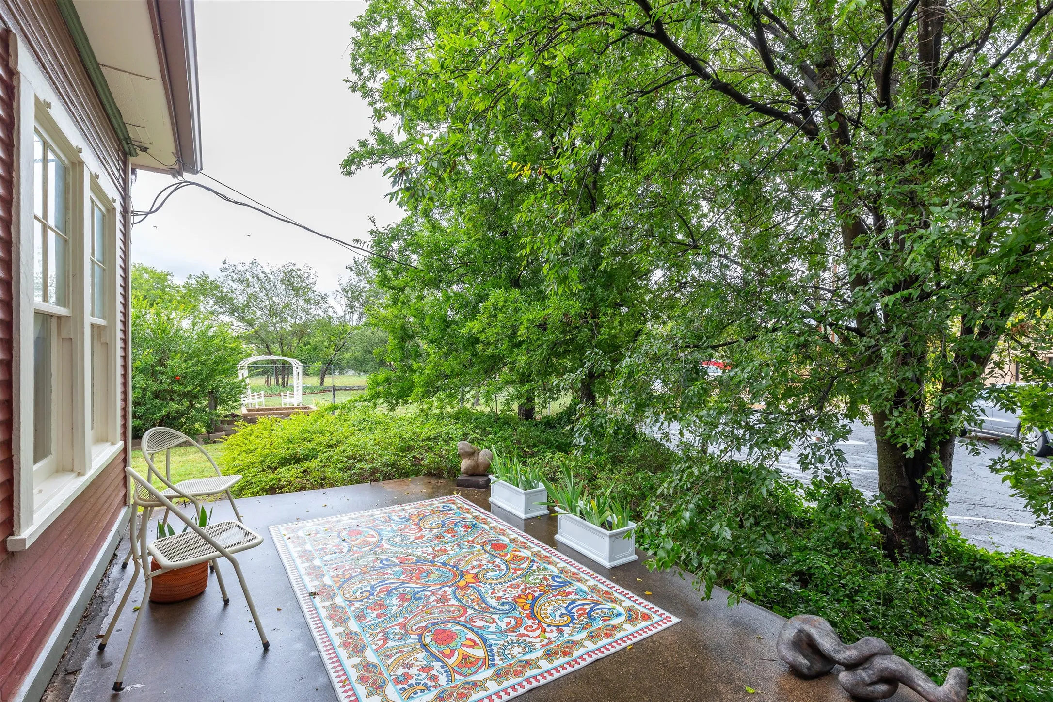 Covered porch with exposed aggregate concrete flooring