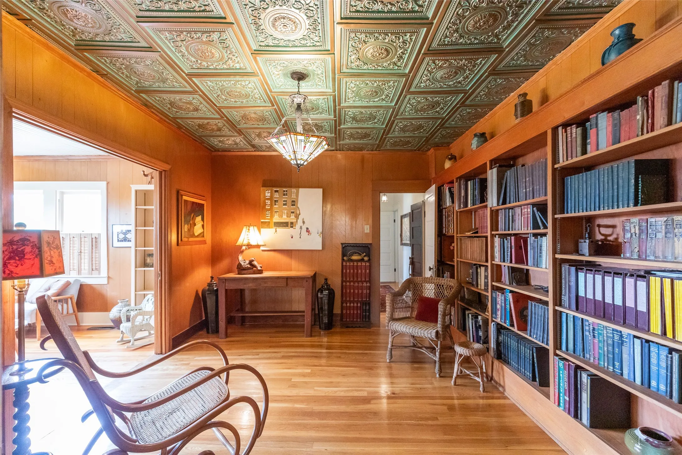 Rich wood-paneled walls and extensive built-in bookcases provide sophisticated storage