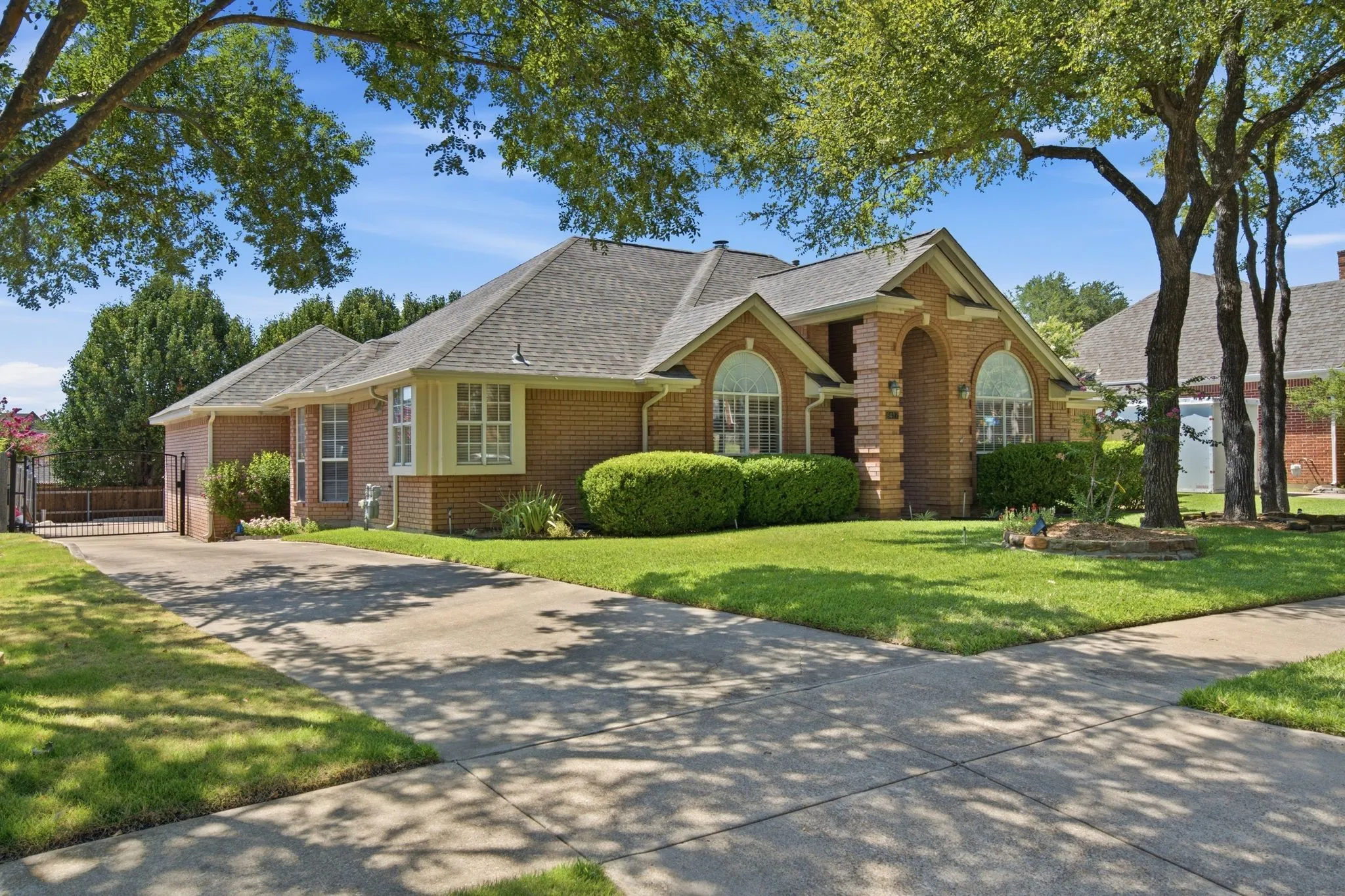 Brick exterior with stone accents and arched window details