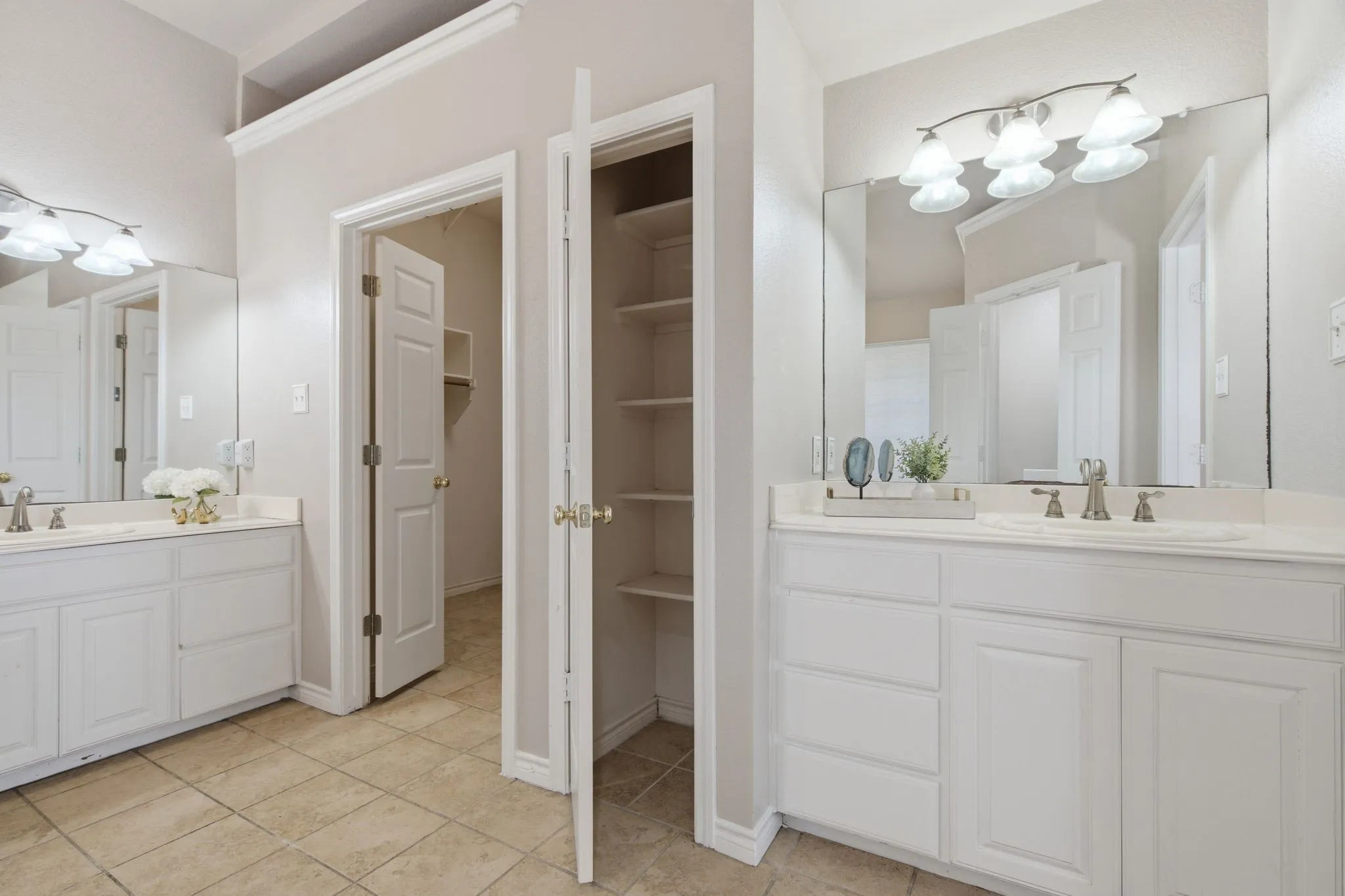 Dual white vanities with integrated sinks and brushed nickel fixtures