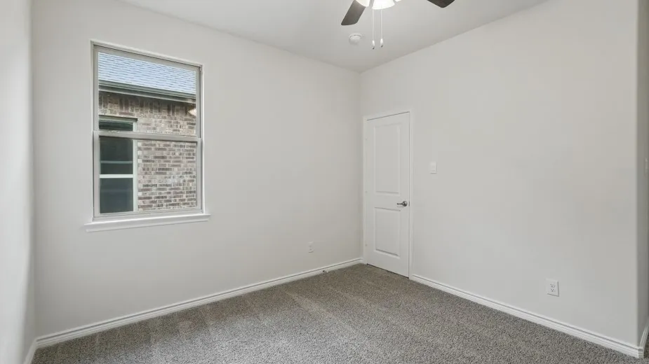 Windowed room featuring light gray wall paint, gray carpet flooring, white trim, and a ceiling fan with integrated lighting