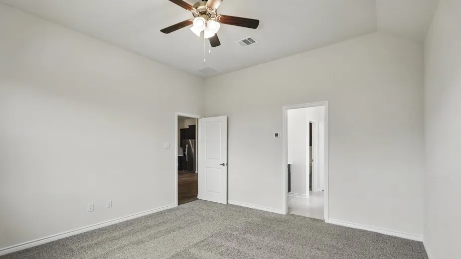 Vaulted ceilings feature a ceiling fan with integrated lighting