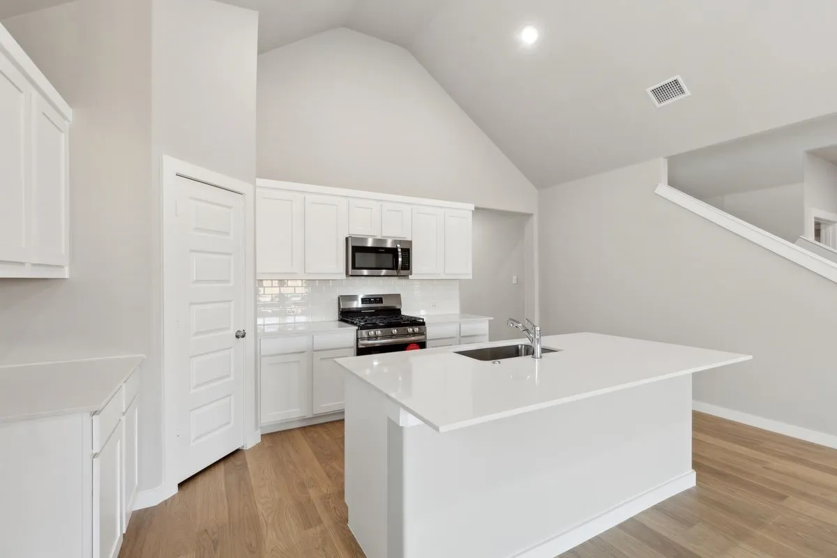 Kitchen in the Claret home plan by Trophy Signature Homes – REPRESENTATIVE PHOTO