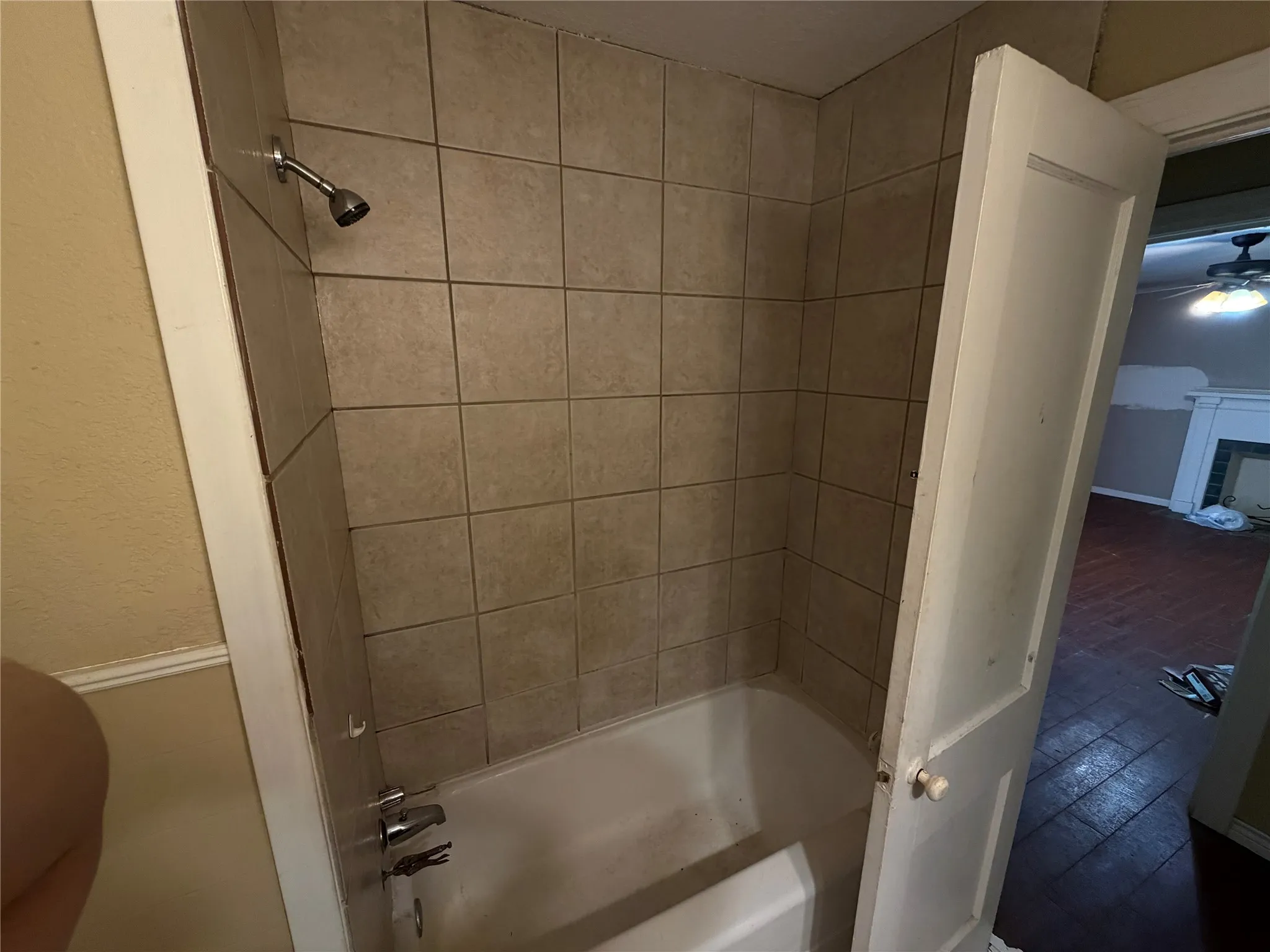 Bathtub with square tile surround and chrome fixtures