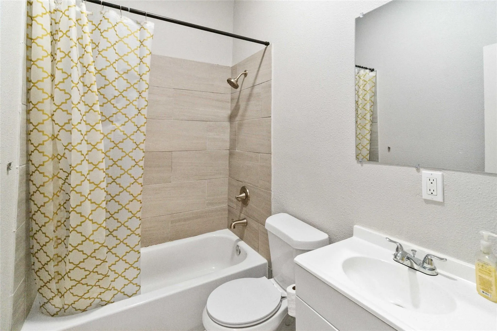 Full bath featuring toilet, shower / bath combination with curtain, and vanity