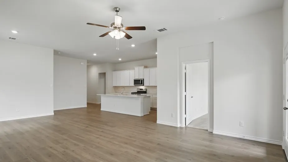 Open-concept living space featuring wood-finish flooring, recessed lighting, and a ceiling fan