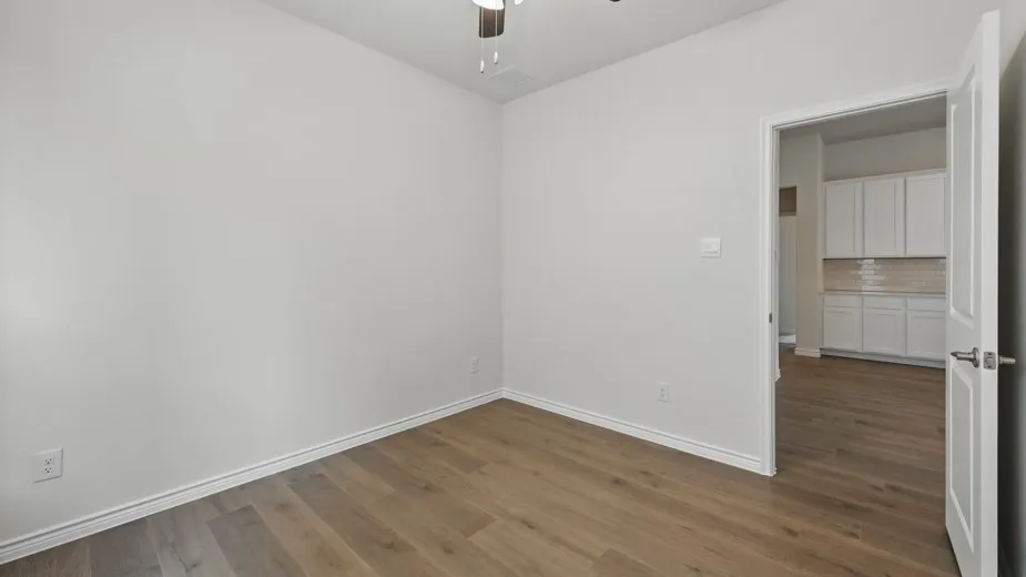 Room featuring light wood-finish flooring and white baseboards