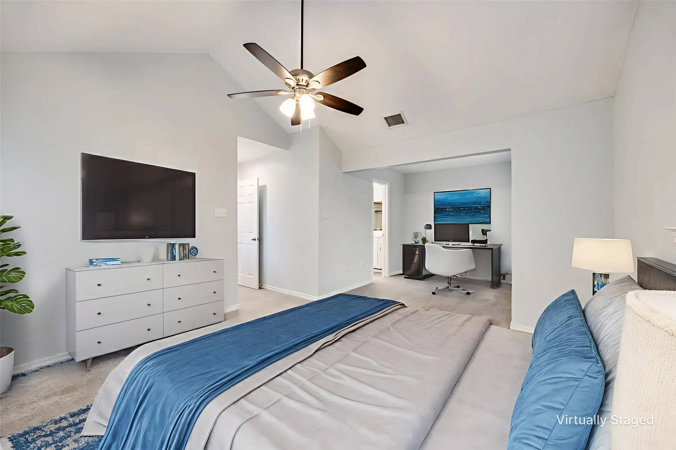 Vaulted ceiling bedroom featuring a ceiling fan, light gray wall paint, and carpeted flooring