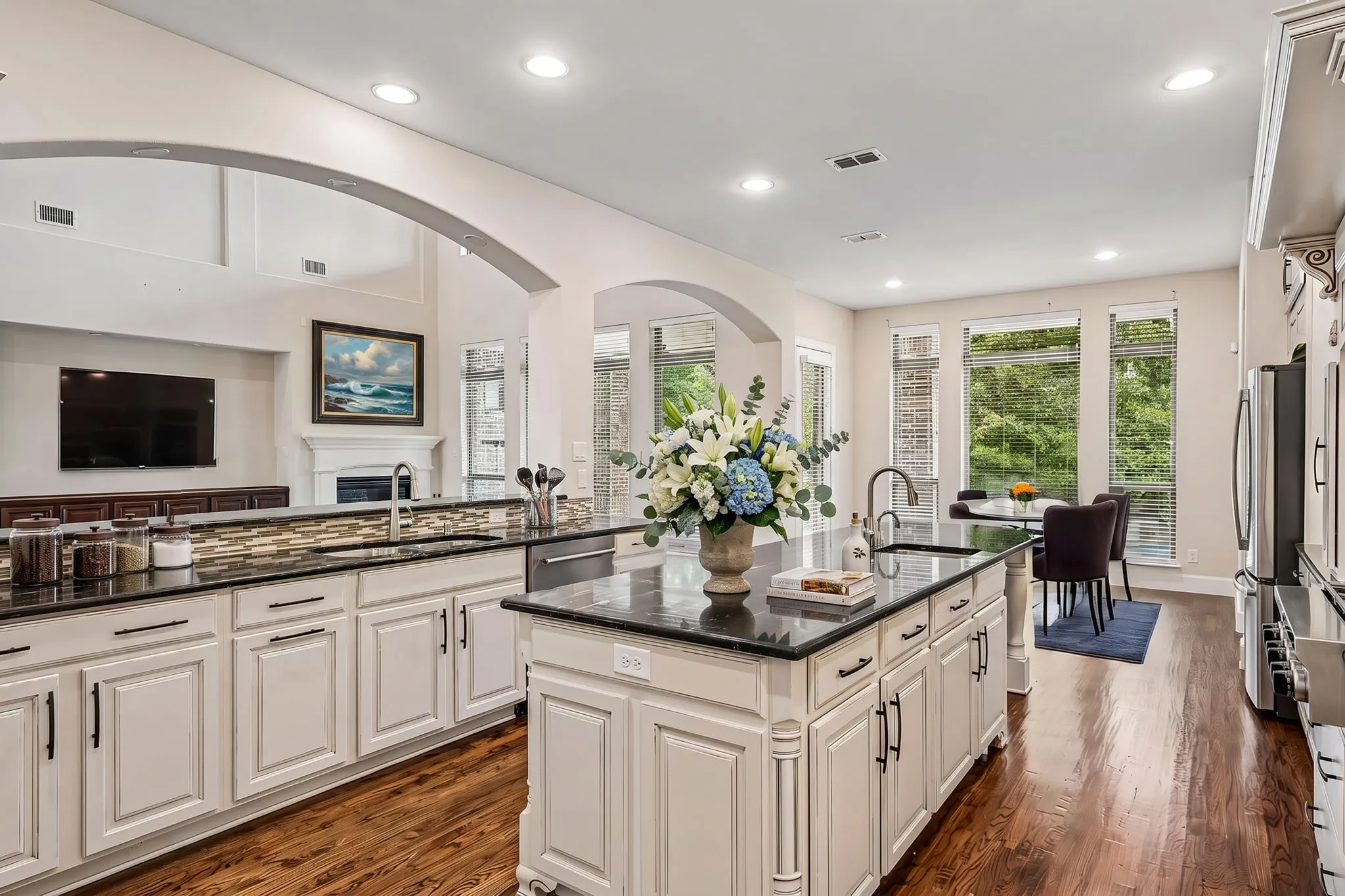 Open concept kitchen and living room w tons of natural light - digitally staged
