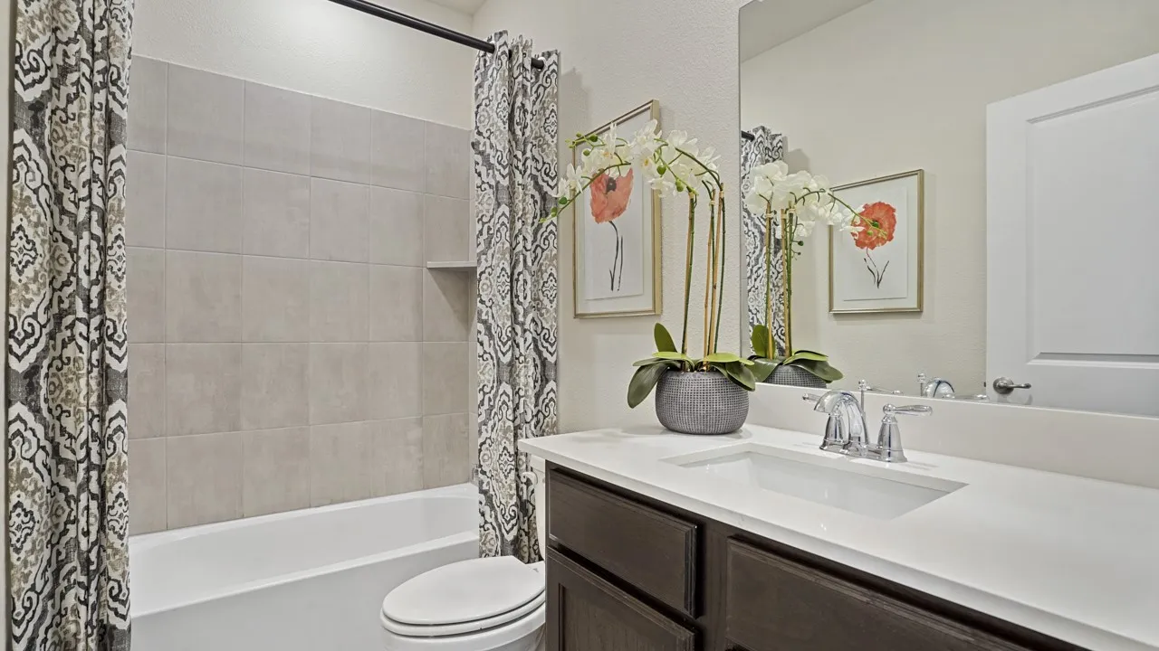 Bathroom featuring a dark wood vanity with a white countertop and an integrated rectangular sink