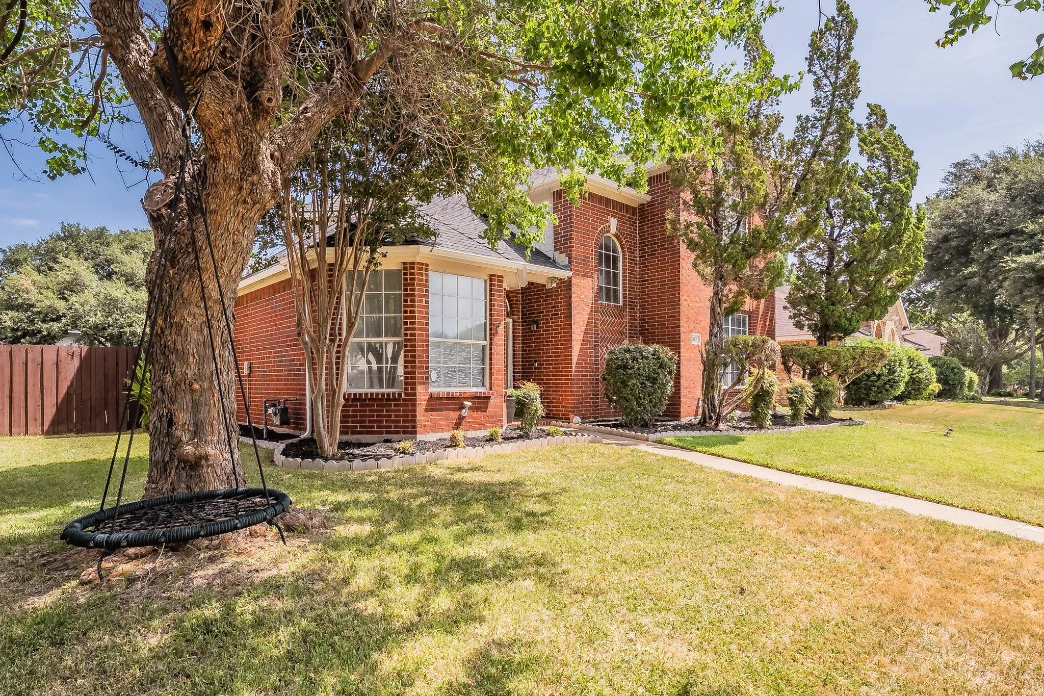 Brick exterior residence featuring a prominent bay window
