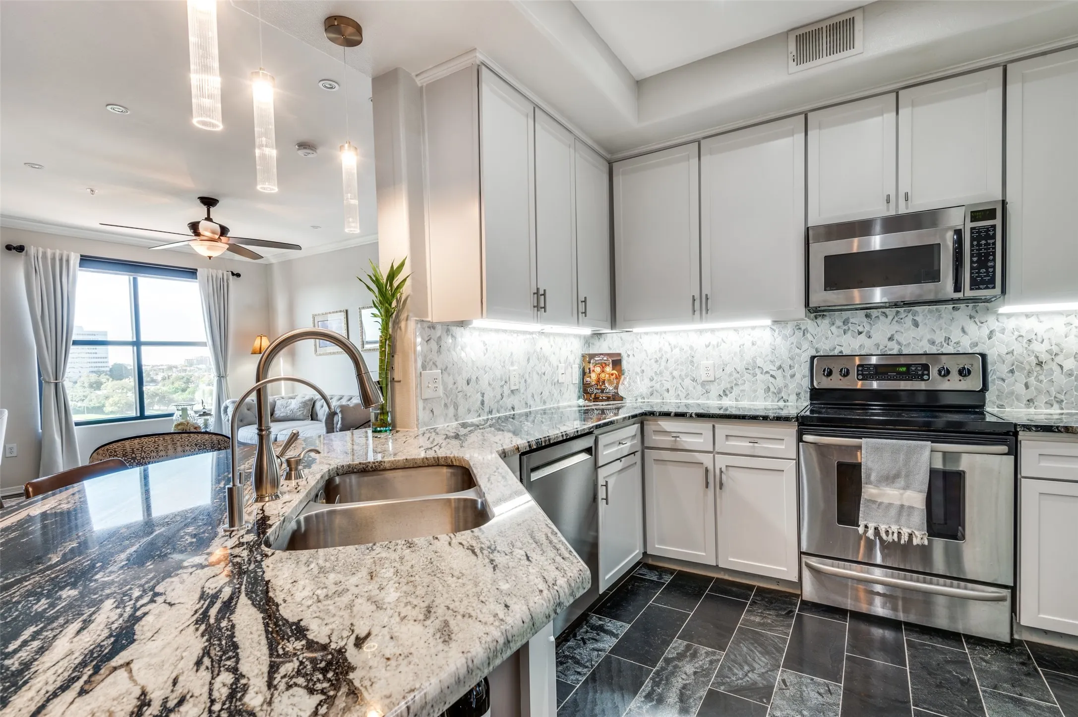 Kitchen with designer granite and backsplash