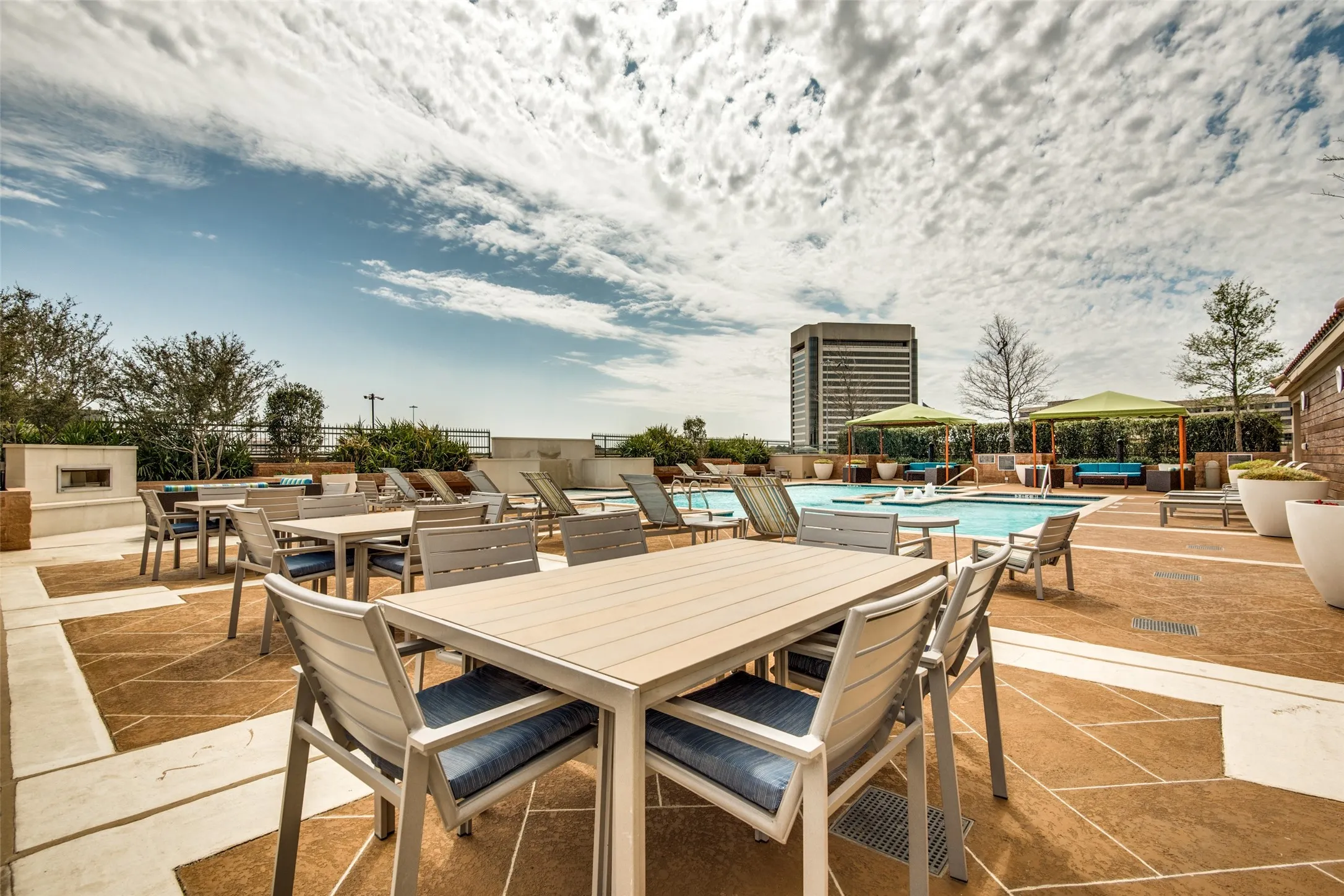 Four lighted gas grills located on the pool deck