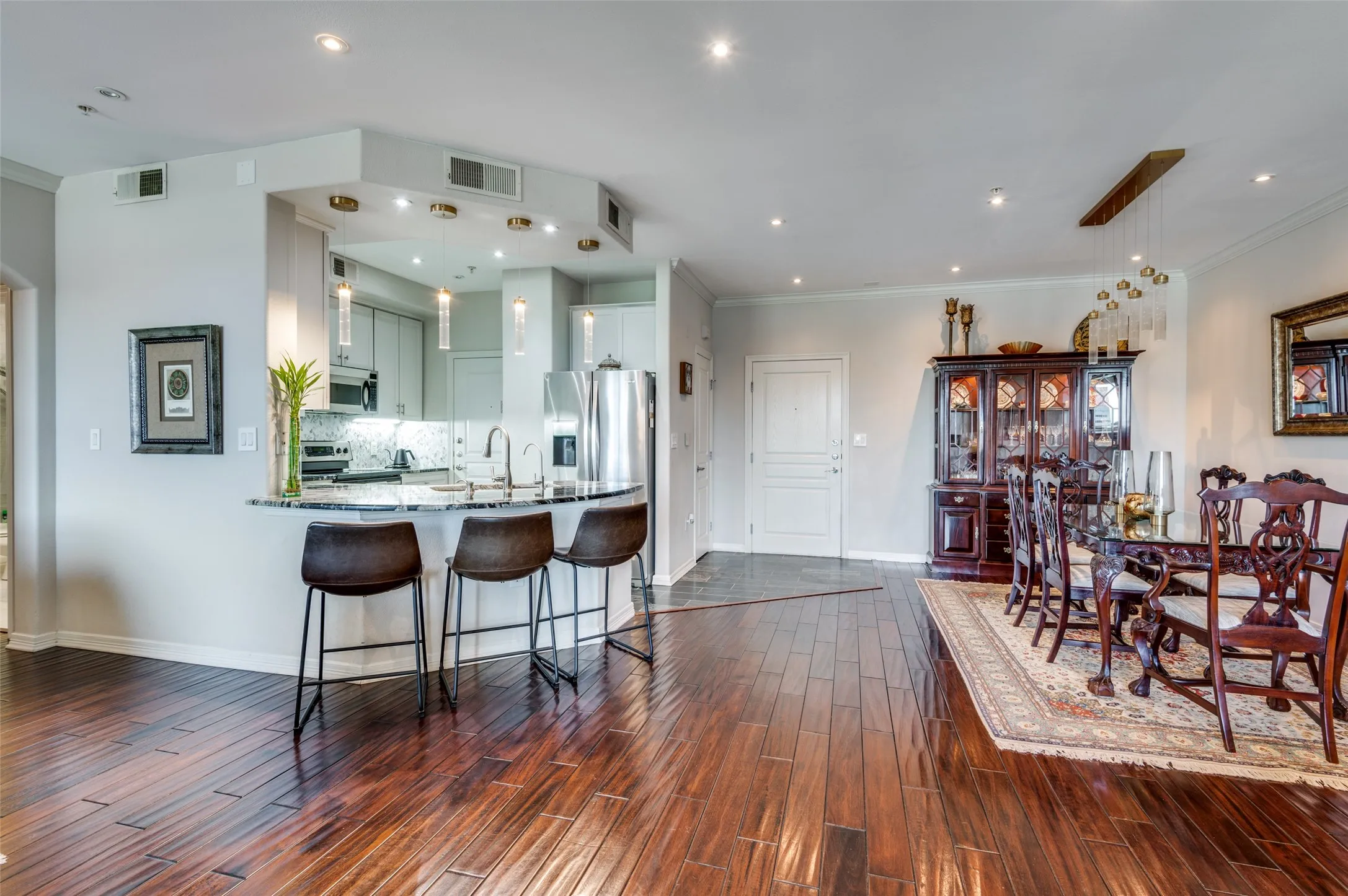 Another view of kitchen and dining room featuring the eat-at dining bar