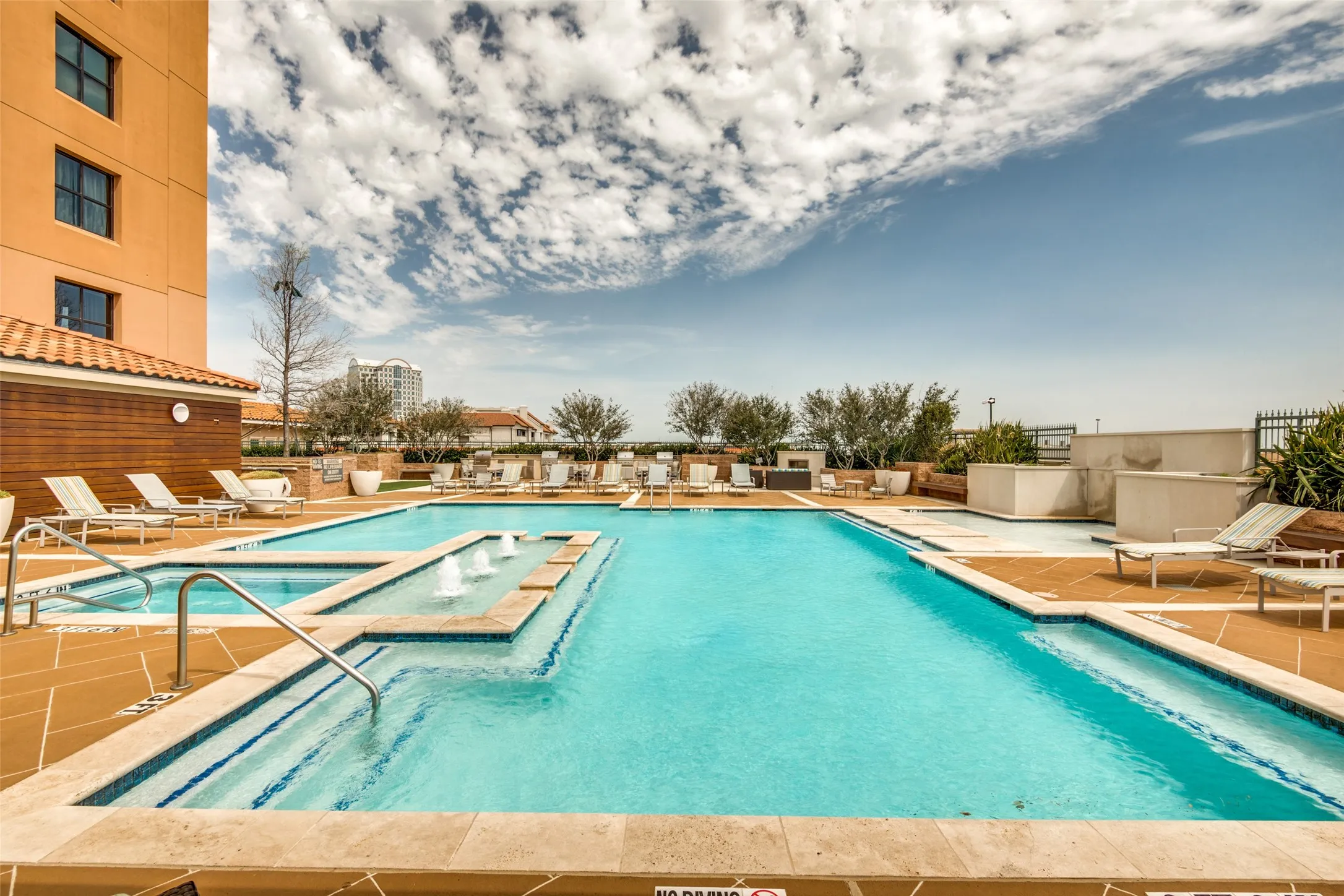 Rooftop pool with hot tub and shaded cabanas