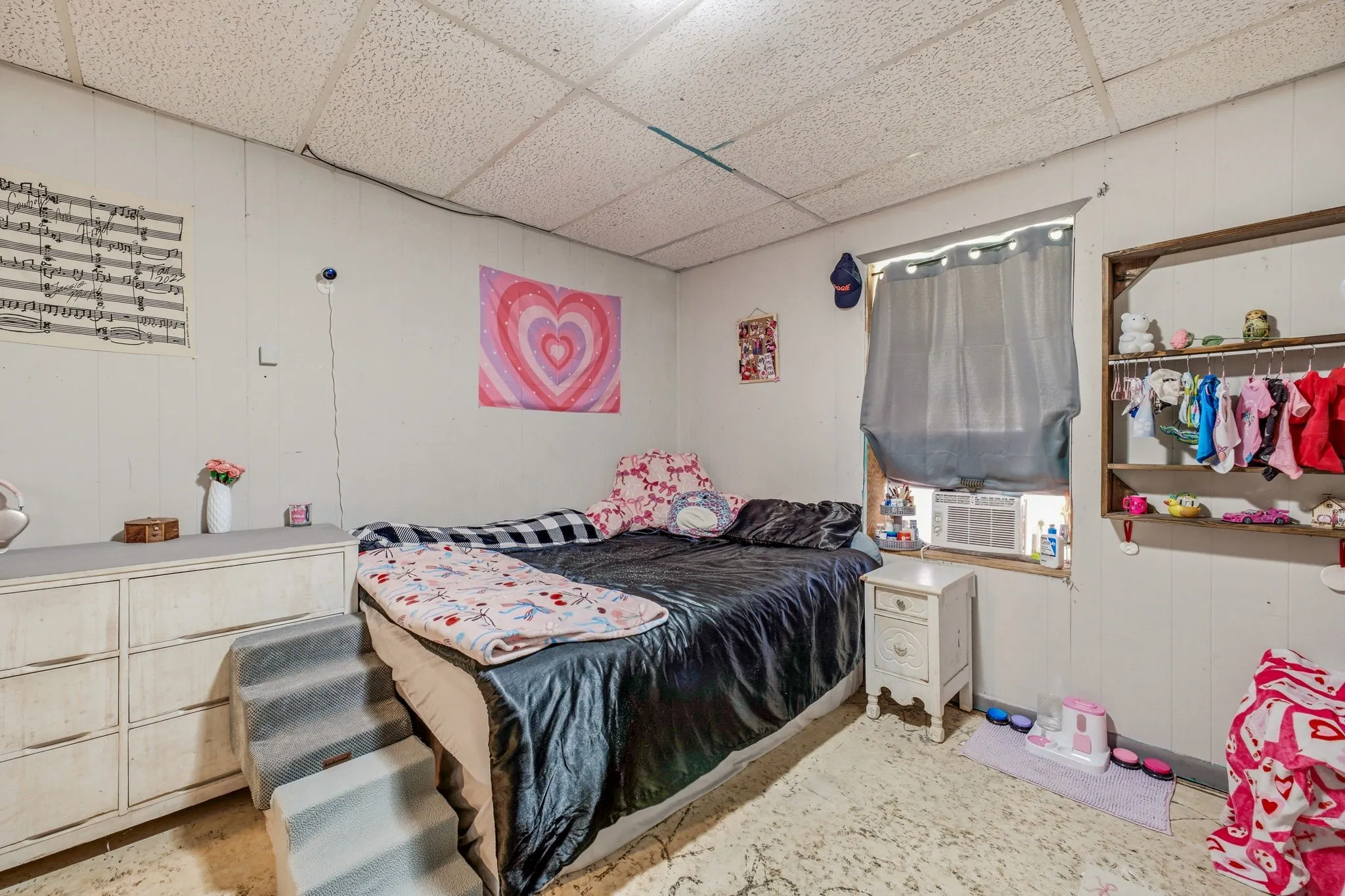 White paneled walls with a drop ceiling
