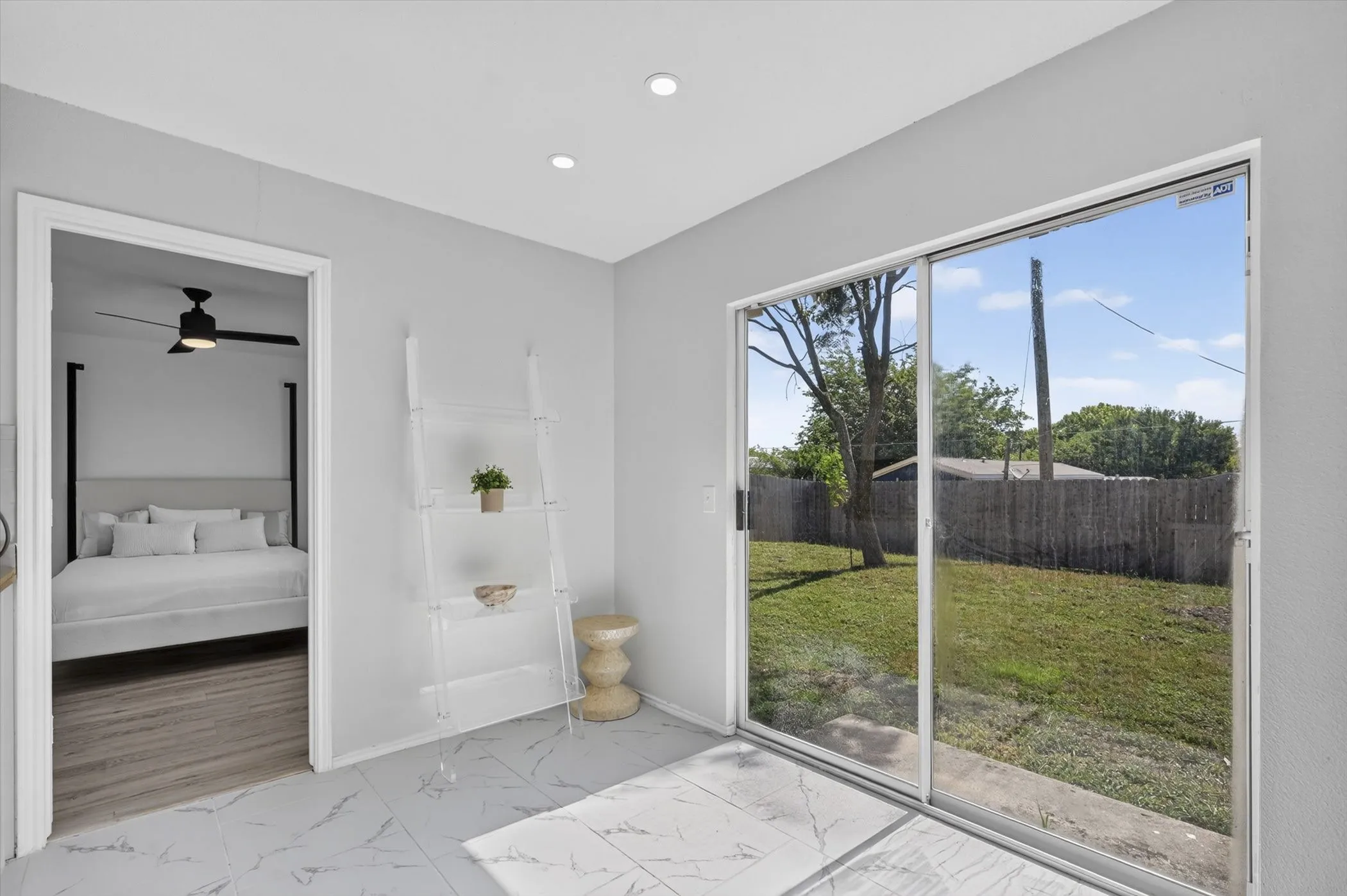 Sliding glass doors opening to a private backyard with a privacy fence