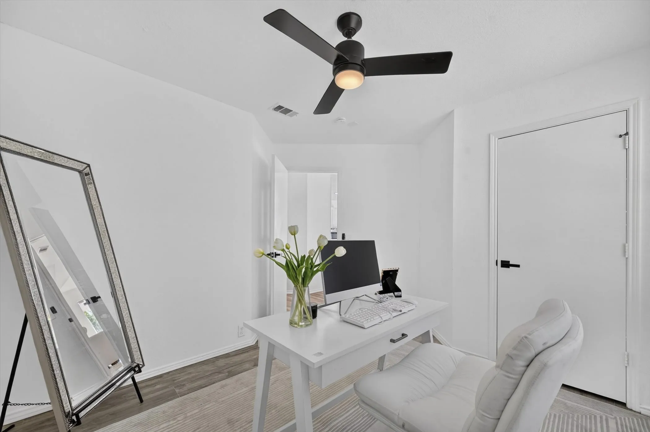 Bright interior space featuring light wood-finish flooring