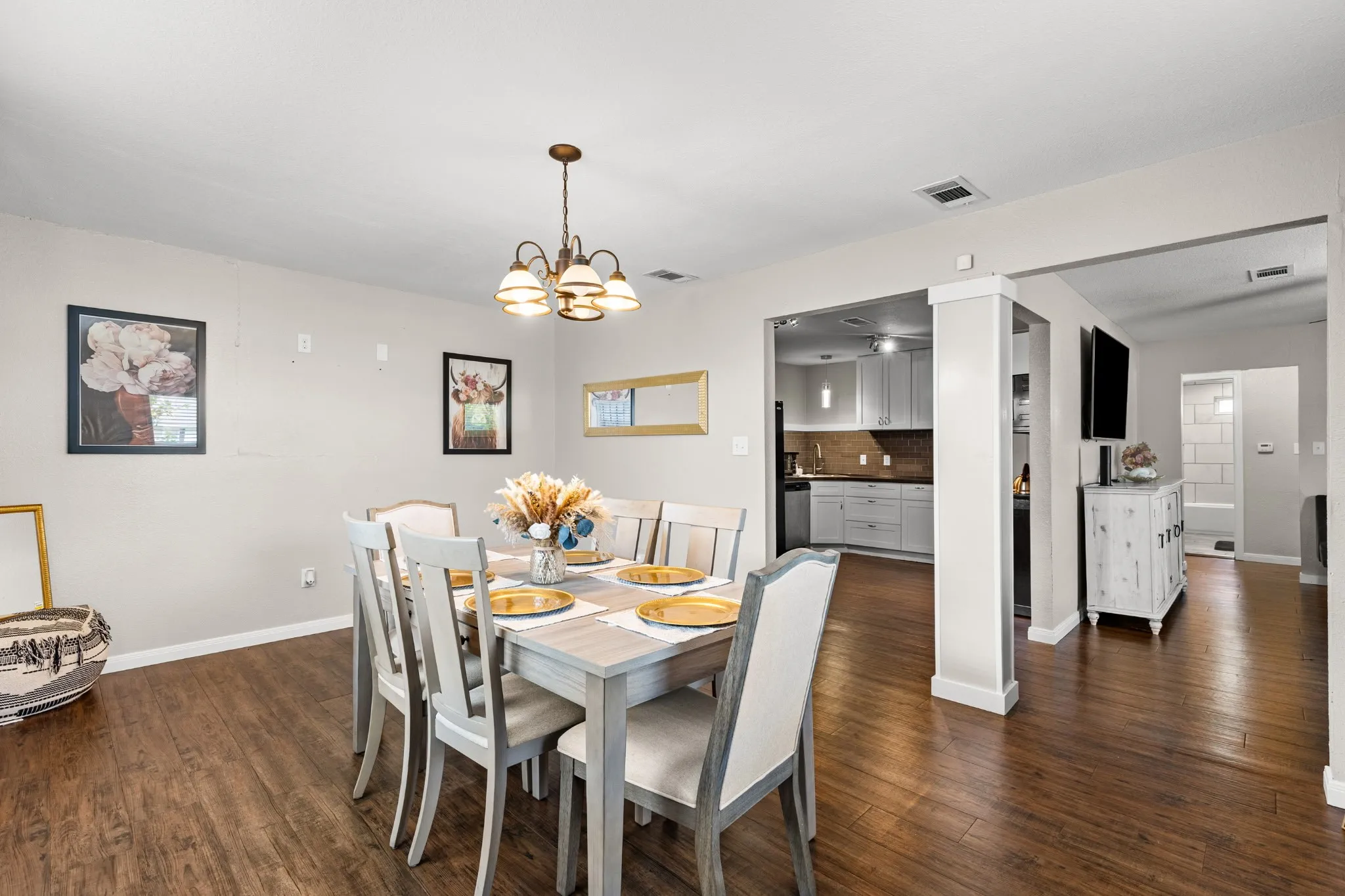 Dining area featuring wood-finish flooring and a ceiling-mounted chandelier