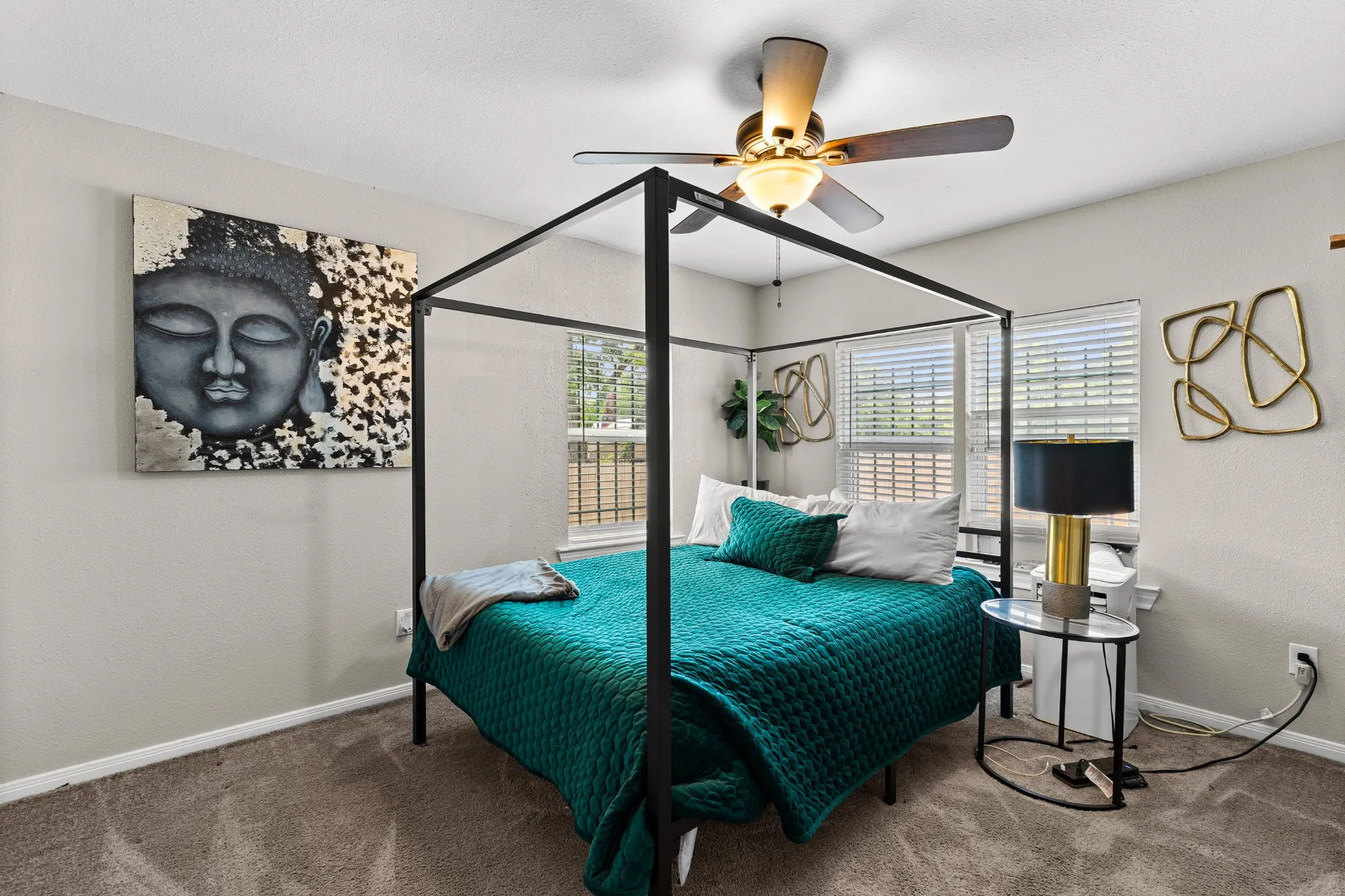 Spacious bedroom featuring neutral wall tones and plush carpeting