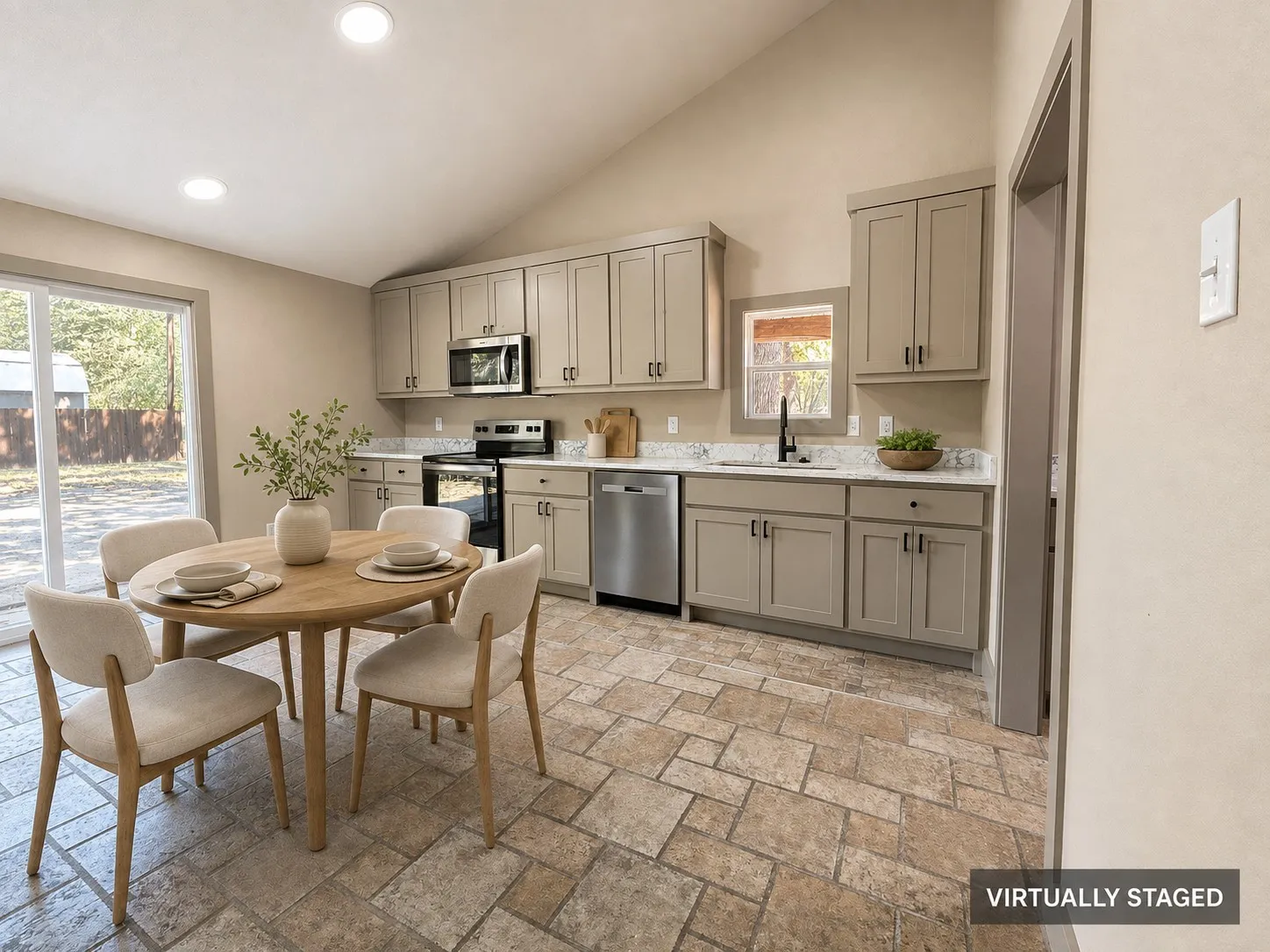Vaulted ceiling with recessed lighting, tile flooring, stainless steel appliances, light-toned cabinetry, and sliding glass door