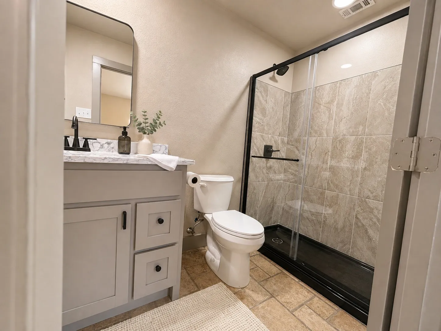 Vanity with quartz countertop and rectangular sink, matte black faucet, and framed mirror